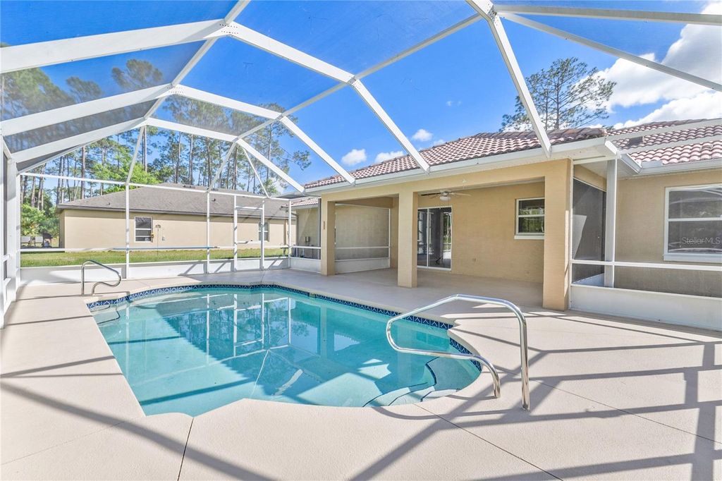 Photo of 120 Point Of Woods Drive, Palm Coast, FL 32164 (MLS # V4948462)