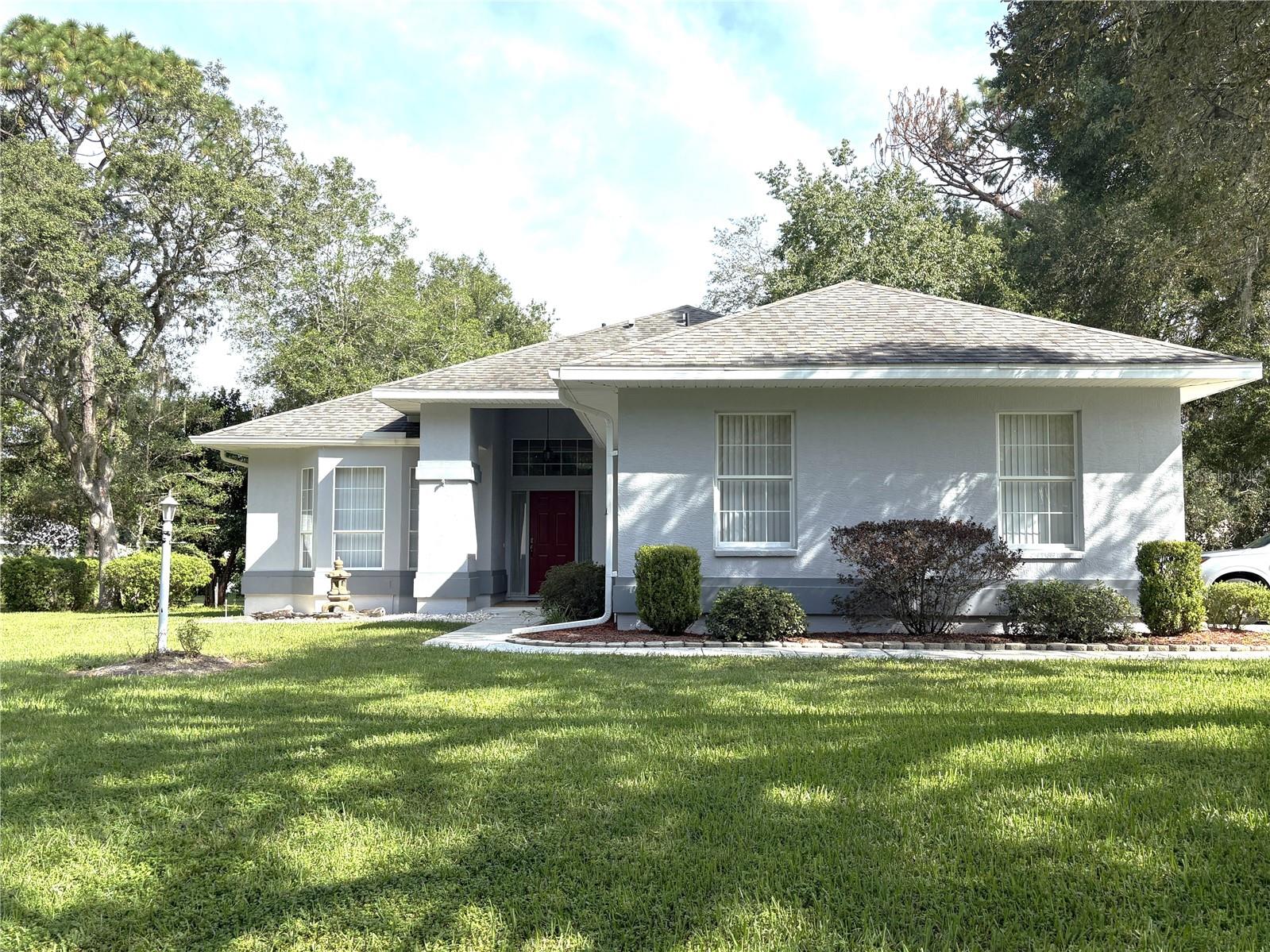 Move in ready, well-maintained home is just waiting for you. This home sits in the highly desirable Country Club Estates of Rainbow Springs. The tree lined streets make this community unique and this home in particular is unique as it sits on one acre. It sits on a small bluff higher than most of the neighbors in the middle of the property so the yard is a haven for the wildlife to visit. The home has been painstakingly maintained. The living area is open to the kitchen and dining area. There are two skylights in the living area that are tempered so rain sounds are calming. The front room is a bedroom but currently used as an office/den. The second bedroom is on the side of the house opposite from the primary bedroom with access to the second bathroom. This allows company to be separate yet still in the middle of all the entertainment. The oversized, screened lanai is a great place to have your first cup of coffee or your afternoon cocktail. There is already a shed on site for your yard care tools which allows your 2 car garage to be open for your 2 cars! So now you know about the house but there is so much more to this community. A member only River Park on the Rainbow River, a community center with workout room, billiards room, several meeting rooms that can be reserved for your favorite card game, a community pool, tennis and pickleball courts, bocce, horseshoes, shufflebaoard, disc golf and more. All this for a low annual assessment of $243.