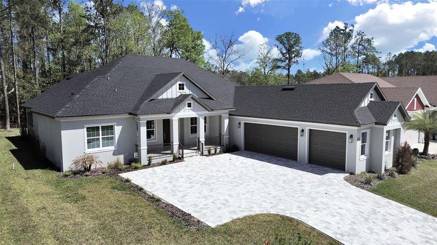 Set amid a tranquil expanse of protected woodlands, this newly built residence in Southern Hills Plantation embodies the quiet elegance and enduring craftsmanship that define exceptional living. The home rests against a natural backdrop of trees with no rear neighbors, creating a rare sense of seclusion within one of the region’s most distinguished private golf communities.

Inside, light flows through open, thoughtfully composed spaces where every detail reveals a dedication to both artistry and function. The gourmet kitchen stands as the centerpiece—a refined blend of form and precision featuring professional-grade appliances, a pot filler, a bespoke coffee bar area, and a sunlit breakfast nook designed for unhurried mornings. Waterfall-edge quartz surfaces and an expansive hidden pantry lend the kitchen a seamless, sculptural quality that is both inviting and remarkably practical.

Beyond the interior, sliding glass doors open to an extended covered lanai where indoor comfort meets the open air. The outdoor kitchen, complete with sink and refrigerator, invites year-round entertaining, with generous space for both dining and lounge seating. Here, gatherings unfold against the serene preserve, offering a setting as suited to lively evenings as it is to quiet reflection.

The primary suite and accompanying baths echo the serenity of a private spa—rainfall showers, refined fixtures, and custom lighting create a sanctuary of calm. Handcrafted wooden closets, illuminated with integrated LEDs, elevate everyday living with a sense of order and intention. A three-car garage and extended driveway provide ample space for vehicles, storage, and guests.

Beyond the front door, Southern Hills Plantation Club offers a lifestyle shaped by world-class amenities, including the private Pete Dye Signature golf course, a classic resort-style clubhouse with dining, and a full-service fitness and aquatic center with resort-style pool. Tennis and pickleball courts, walking trails, and the gated setting further enhance the sense of retreat while remaining within easy reach of Tampa Bay. From its carefully curated interiors to its exceptional club environment, this residence is an invitation to experience luxury living that feels both graceful and timeless.