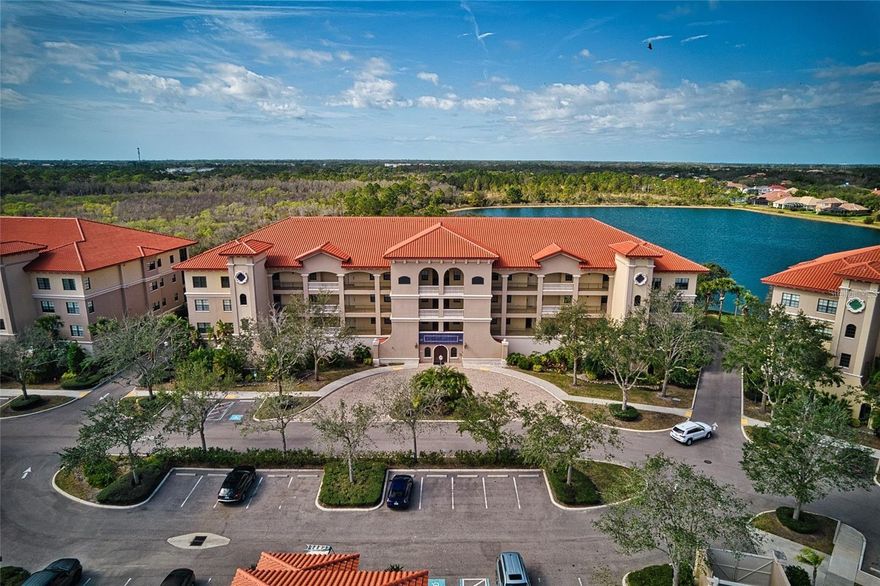 Lake Vista Residences is a gated condo community with no CDD, a great security system in place with key fobs to enter the facilities, a clubhouse, heated pool, spa, fitness room, a kitchen for catering, conference room and professional on-site management. The location is top notch in central Lakewood Ranch, near Main Street and the hospital, a short walk or drive to restaurants, shops, movie theater, and mini golf. Easy access to I-75 to get to the area’s best attractions, not far from the UTC Mall, Benderson Park and the new Waterside. Upon arriving, the mature landscaping will impress. The entire complex had all new roofs in 2022 and the roof assessment has been paid in full. ($8,100) When you enter this move in ready condo you appreciate the spacious open concept layout with lots of natural light and a great lake and preserve view from the lanai! The screened-in balcony can be accessed from the master suite as well as the living room. The interior has been beautifully updated with fresh paint throughout, new carpet in the bedrooms, updated walk-in shower and tile in the master bathroom, with dual sinks and a corner soaking tub. The master bedroom has a tray ceiling, crown molding, walk in closet and bonus closet. The large kitchen features a tray ceiling, granite countertops with matching backsplash, wood cabinets, an island, breakfast bar, a nice size pantry cupboard and stainless steel appliances. The Second bedroom also boasts a large closet with adjacent spacious bathroom with a walk-in shower with a glass door. The large laundry room has a built-in counter, rail for clothes drying, sink, upper cabinets for extra storage a washer and a dryer. The living area has electric blinds. Blinds at all windows are included as are the fans and wall light fixtures. Outside, the hallway has a trash chute and recycling for paper and plastic. The condo comes with one parking space and one storage unit in the private parking garage. Guest parking is also available.