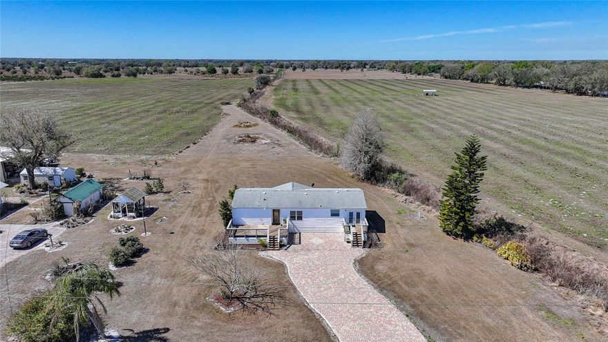 Nestled on 10 beautiful acres in a quiet, peaceful neighborhood, this property offers the perfect blend of privacy and space. A large paver driveway welcomes you home, creating impressive curb appeal and ample parking. Enjoy the outdoors from two exterior decks, ideal for relaxing, entertaining, or simply taking in the surrounding views. Major improvements include a newer roof and a new well and water softener system installed in 2024, giving buyers added confidence and long term value. Inside, you’ll find tall ceilings and a bright, open-concept living and dining area that creates an inviting and spacious atmosphere. The open kitchen features a cozy breakfast nook and a convenient laundry closet, making everyday living both comfortable and functional. The large primary suite is a true retreat, complete with a walk-in closet and an en suite bathroom offering dual sinks, walk-in shower, and standalone soaking tub. The split floor plan provides privacy, with spacious guest bedrooms that also feature walk-in closets and easy access to the guest bathroom. With 10 acres of land, there is plenty of room to spread out, explore, or expand. Additionally, this property offers the opportunity to lease the land for cattle or sod, an excellent option for those looking to generate potential income. Ask for more details on this unique opportunity!