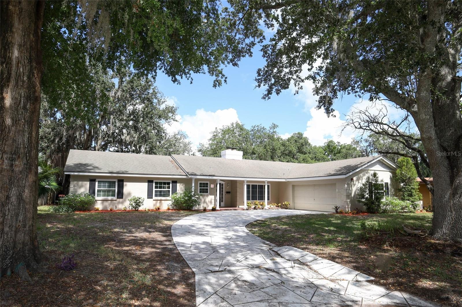 Located in the sought-after and well-established neighborhood of English Estates in Maitland, this beautifully updated 4-bedroom, 2-bath home offers incredible curb appeal and comfort throughout. Step inside to a spacious layout featuring a HUGE living room with a cozy wood-burning fireplace. The updated eat-in kitchen is outfitted with all-wood cabinetry, quartz countertops, a stainless steel sink, and a full suite of appliances—perfect for casual meals and family gatherings. Adjacent to the kitchen is a convenient laundry room with abundant cabinetry for storage. All bedrooms showcase attractive, low-maintenance wood-look laminate flooring, and the master suite includes an ensuite bathroom with shower and a versatile bonus room—ideal as a home office, reading nook, workout space, or private retreat. The guest bath features a walk-in shower and is handicap accessible for added convenience. Just off the living room, a screened-in porch invites relaxation while overlooking the large backyard, offering plenty of space for entertaining, play, or peaceful evenings outdoors. Additional features include an electronic keypad entry with mag lock, a video security system, a fire alarm, and a full sprinkler system for peace of mind. Situated near parks, bike trails, restaurants, shopping, and major expressways including I-4, SR436, and 414, this home combines lifestyle and location. Zoned for top-rated Seminole County Schools, this move-in ready home is just minutes from downtown Winter Park. Don’t miss your chance to own this gem—schedule your showing today!