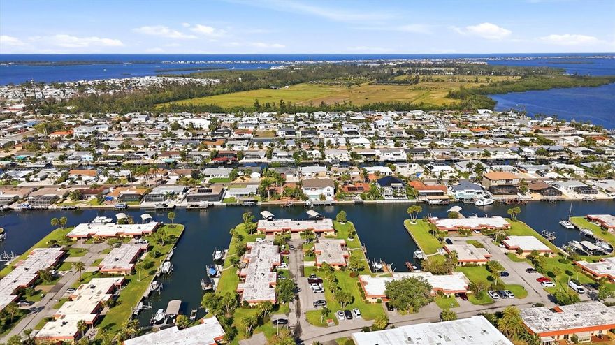 Gated waterfront living in Palma Sola Harbour! Your dream condo is here! This beautifully updated 2-bedroom, 2-bath condo is ideally situated on a peaceful canal, offering tranquil water views right from your living room. The open floor plan seamlessly connects the kitchen, living, and dining areas, all featuring continuous large plank tile flooring throughout.

The dining room includes built-in cabinetry and flows into a stunning, fully updated kitchen with 36-inch upper cabinets, an eat-in island, new stainless steel appliances, an induction stove, and recessed lighting.

Relax and take in the water views from your enclosed lanai, which overlooks an expansive 37’ x 16’ outdoor lanai adorned with pavers—perfect for entertaining or unwinding.

The primary bedroom features tile flooring, a walk-in closet, and a beautifully updated en-suite bathroom with a walk-in shower. The second bedroom offers built-in cabinets and tile floors, with easy access to a hall bathroom with a tub/shower combination and a linen closet.

Updates are extensive and include fresh interior paint, new fixtures and ceiling fans, remote-controlled blinds in the lanai, new interior doors, newer A/C (2020), roof (2021), and hurricane-impact windows. The spacious carport includes additional storage cabinets.

This pet-friendly community allows two dogs with no weight limit and offers an on-site property manager. Residents enjoy a vibrant social atmosphere with monthly gatherings and happy hours. No age restictions in this community.  Amenities include two heated swimming pools, tennis courts, shuffleboard, a putting green, fitness center, billiards room, workshop, two Swedish-style saunas, and an active clubhouse with social events.

A fantastic opportunity to embrace relaxed coastal living in a sought-after waterfront community, just under 3 miles from our beautiful  sandy beaches!  Schedule your private showing today!