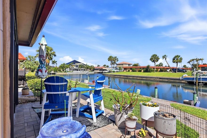 Gated waterfront living in Palma Sola Harbour! Your dream condo is here! This beautifully updated 2-bedroom, 2-bath condo is ideally situated on a peaceful canal, offering tranquil water views right from your living room. The open floor plan seamlessly connects the kitchen, living, and dining areas, all featuring continuous large plank tile flooring throughout.

The dining room includes built-in cabinetry and flows into a stunning, fully updated kitchen with 36-inch upper cabinets, an eat-in island, new stainless steel appliances, an induction stove, Induction cooking pans icluded) and recessed lighting.

Relax and take in the water views from your enclosed lanai, which overlooks an expansive 37’ x 16’ outdoor lanai adorned with pavers—perfect for entertaining or unwinding.

The primary bedroom features tile flooring, a walk-in closet, and a beautifully updated en-suite bathroom with a walk-in shower. The second bedroom offers built-in cabinets and tile floors, with easy access to a hall bathroom with a tub/shower combination and a linen closet.

Updates are extensive and include fresh interior paint, new fixtures and ceiling fans, remote-controlled blinds in the lanai, new interior doors, newer A/C (2020), roof (2021), and hurricane-impact windows. The spacious carport includes additional storage cabinets.

This age friendly, pet-friendly community allows two dogs with no weight limit and offers an on-site property manager. Residents enjoy a vibrant social atmosphere with monthly gatherings and happy hours. No age restictions in this community.  Amenities include two heated swimming pools, tennis courts, shuffleboard, a putting green, fitness center, billiards room, workshop, two Swedish-style saunas, and an active clubhouse with social events. Enjpy paddle boarding,rowing and fishing on the canal out your back door. 

A fantastic opportunity to embrace relaxed coastal living in a sought-after waterfront community, just under 3 miles from our beautiful  sandy beaches!  Schedule your private showing today!
