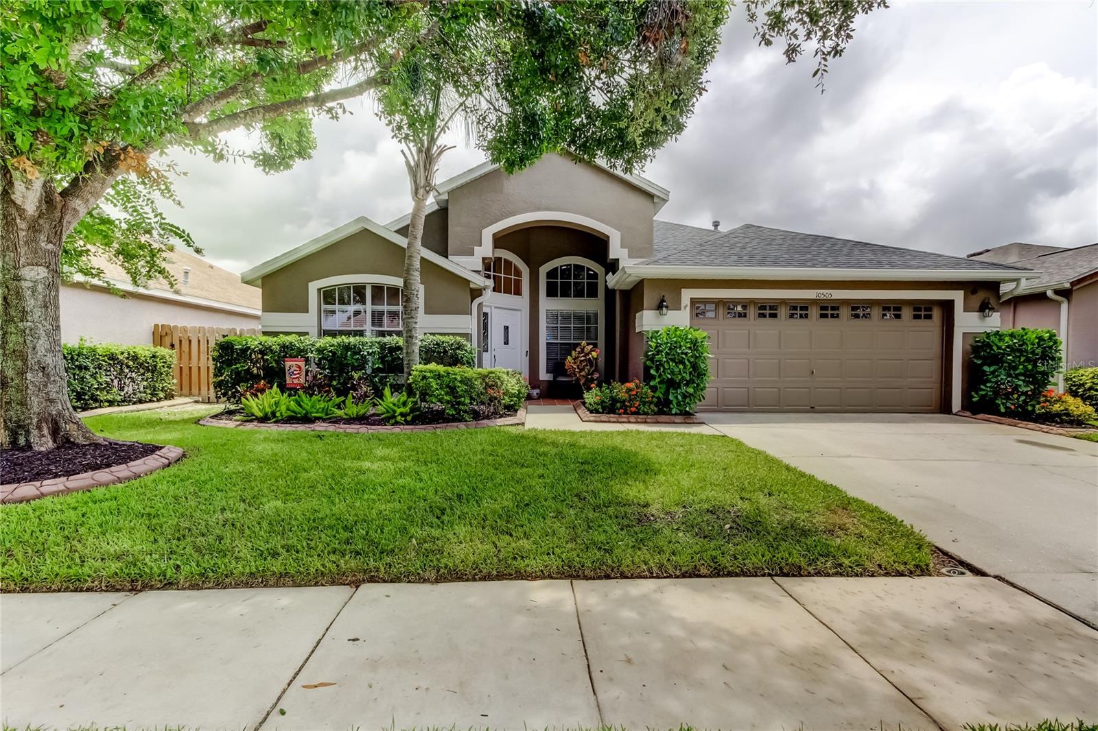 Now available in the heart of WESTCHASE is this beautiful SOLAR HEATED POOL home in the highly sought-after FORDS of WESTCHASE. Boasting one of the community’s largest backyard and pool areas, your dream home welcomes you! Located in a NO FLOOD ZONE, this meticulously maintained 3 Bedroom, 2 Bath residence offers a perfect blend of comfort, functionality, and style. The formal living (currently a play room area) and dining room combo is ideal for entertaining, while the open family room flows seamlessly through the triple sliding door, into the covered lanai (17x13) and the enclosed pool area (24 x 36) – perfect for relaxing or hosting year-round gatherings. Large solar heated pool is a curvy 26 x10! NEW pool pump, filter and salt cell installed in 2025 for worry-free enjoyment! The luxurious primary suite features a custom closet, lots of natural light, and private sliding glass door access to the pool. The spa-like ensuite bathroom includes a water closet, a wonderful frameless glass shower, a generously sized soaking tub, and dual vanities. The well-equipped laundry room boasts abundant storage, keeping everything organized and tucked away. A two-car garage with plenty of shelving adds extra functionality. Enjoy backyard peace and privacy with a NEWLY installed privacy fence and gates (2024). Additional updates/improvements include the NEWER 3.5 ton 16 seer Trane HVAC (2020), NEWER roof with 10 year warranty (2021), AC purifier added to AC unit (2024), refrigerator (2019), dishwasher (2021) and NEW dining and foyer lighting fixtures (2025). Nestled in an extremely desirable community with endless sidewalks ideal for walking or biking, you’ll also enjoy access to a community pool, tennis courts, and a fantastic playground. Don’t miss the rare opportunity – schedule your private showing today!