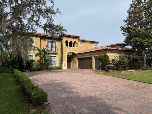 Must see Resort Style living, this beautiful Mediterranean-style home is spacious with an open floor plan perfect for large family gatherings and entertainment. The property features high ceilings including the living room 20 feet height ceilings (approximately). The gourmet kitchen includes granite countertops, food preparation island, breakfast bar nook off of the living room area, with a wine cellar. This spacious floor plan features the first floor Primary bedroom, with en suite bath, and an additional bedroom that could be used for a den or an office with a private bath. The open floor plan allows views and access to your enclosed patio (lanai) from the living room via sliding glass pocket doors and private backyard. The second-floor features a deck overlooking the back yard area, a balcony that overlooks the family area and a dual access staircase, two additional bedrooms, another full bath and a foyer which can be used as office space. Extras included with this home are a video projection room with all projection equipment and the chairs, an additional game room with a pool table and a built-in wet bar. Other features are tile roof, mature landscaping surrounding the entire property for added privacy. The community offers a clubhouse, pool, splash pad, park, fitness center, riverfront park with dock and community boat ramp which allows access to the St. John's River. The Riviera Bella community is located near Heathrow office park, multiple malls, 2 golf courses, Hospital and entertainment areas. With easy access to Interstate I-4 and the new Sun-Rail station (approximately 3 miles), close to Central Florida beaches, Daytona Beach is approximately 35 minutes. This home is move-in ready to start your Florida Living.