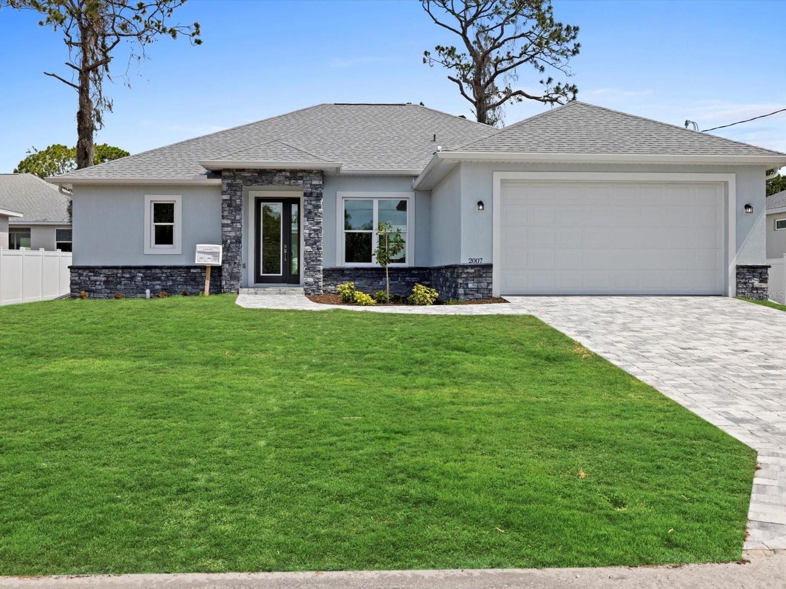 One or more photo(s) has been virtually staged. Pre-Construction. To be built. NO HOA RESTRICTIONS!! This floor plan offers 1,975 square feet of open living space with 3 bedrooms, 2.5 bathrooms, and a large backyard space. Inside, you’ll find 10-foot ceilings in the kitchen and living room, giving the space a bright and open feel. The kitchen features a large waterfall island, stainless steel appliances, soft-close cabinets, and plenty of counter space—perfect for cooking and entertaining. Wood-look tile flooring runs throughout the home, and impact windows let in lots of natural light while keeping the home secure and energy efficient. The master bedroom includes its own private bathroom, while the other two bedrooms offer plenty of space for family or guests. Located close to shopping and dining, this home is designed for easy living in a great location—without the extra costs or rules of an HOA. With quick access to I-75, driving to Sarasota, Naples, Tampa or Venice is a breeze! Reach out today to choose the final finish selections and make this house your very own!