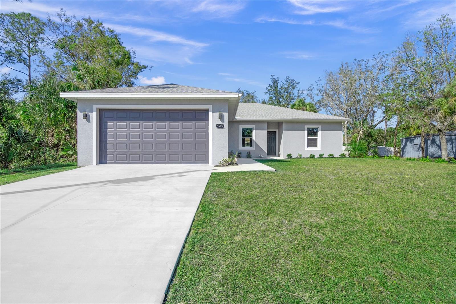 One or more photo(s) has been virtually staged. Seller will pay $5,000 at closing towards Buyer(s) closing costs and prepaids!! This BEAUTIFUL 2023 construction home has NEVER BEEN LIVED IN and is located in North Port. What a dream! Owner has spared no expense and provides a well-built home with stem wall, concrete, block, stucco construction and has included IMPACT WINDOWS throughout. The tray ceilings, crown molding, wainscot, oversized baseboards, and feature wall in great room, all contribute to an elegant atmosphere. The modern kitchen cabinets, quartz countertops, stainless steel appliances, pendant lighting, ceiling fans, natural colors throughout, ceramic tile and laminate flooring (NO CARPET) create a contemporary and stylish feel. The bathrooms have been tastefully completed with beautiful cabinets, fixtures, and upgraded tile including floor to ceiling tile in the primary shower. The windows throughout have been finished with solid sills. The extended patio includes double doors and brick pavers for your enjoyment. A beautifully landscaped backyard makes for a peaceful retreat. The epoxy flooring in the garage enhances the functionality and appeal of this amazing home. And as an added bonus, there are NO HOA and NO CDD fees. Located close to where the Sarasota Memorial Hospital will be building their new facility. And you are not too far from the Cool Today Park where the Atlanta Braves have spring training, or the famous Venice beaches. Make your appointment today to see this AMAZING home.