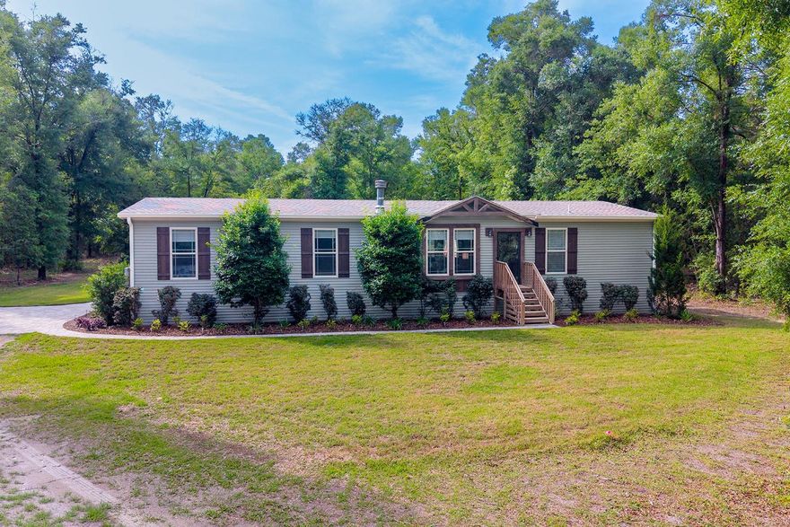 Nestled in the heart of Gilchrist County near High Springs, this beautifully maintained 3-bedroom, 2-bath home offers the perfect blend of peaceful country living and modern comfort on 10 gorgeous acres. From the moment you arrive, the beautifully landscaped yard and paved parking pad with pavers create a warm and inviting first impression. Step outside to enjoy the stunning paver patio and cozy fenced backyard area — perfect for relaxing evenings, entertaining guests, or enjoying the quiet surroundings. Inside, the home has been lovingly cared for and offers a comfortable layout designed for everyday living. Whether you're looking for space to spread out, room for animals or hobbies, or simply a private retreat surrounded by nature, this property delivers. Located just minutes from the crystal-clear springs, rivers, and outdoor recreation that make the High Springs area so desirable, you'll enjoy easy access to kayaking, boating, hiking, and some of North Florida’s most beautiful natural attractions. Conveniently situated between Gainesville and Lake City, this property offers the tranquility of country living while still being close to shopping, dining, and everyday conveniences
