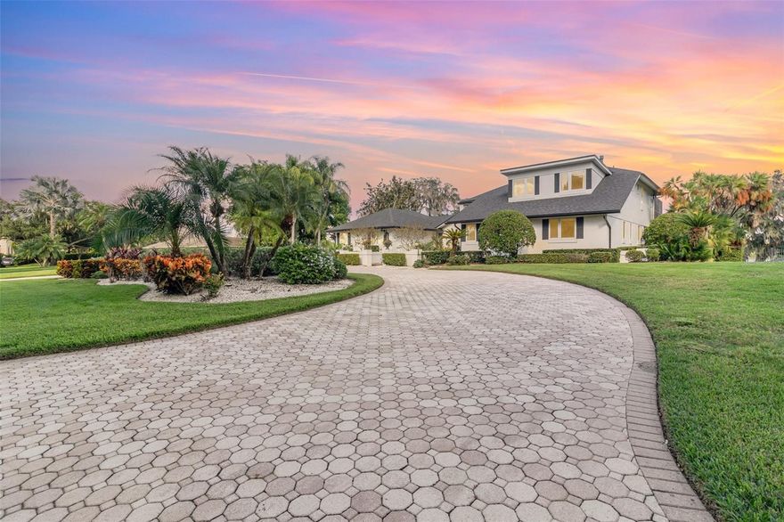 One or more photo(s) has been virtually staged. Selected photo(s) are virtually staged. UNIQUE & LUXURIOUS WATER-FRONT-LAKE property, showcasing a MEDITERRANEAN COTTAGE DESIGN with a custom HEATED POOL.  This luxurious & HOA FREE home offers BREATHTAKING VIEWS OF THE LAKE!  Imagine yourself enjoying this unique home featuring 5 x bedrooms and 4 x bathrooms, along with a 2-car garage capable of accommodating up to 6 vehicles, a carport for 2 cars, and all within a 3.5-acre lot in the highly desirable Windermere area!  Upon entry, this home reassembles the cottage-style homes, evoking a fairytale vibe with their steep but flared VAULTED CEILING, elaborate entryway, asymmetrical design and free-flowing garden.  The ELEGANT KITCHEN is designed for function and style, offering GRANITE COUNTERTOPS, highly durable and shiny appliances, double built-in ovens, a gas cooktop, plenty of counter and cabinet space, and beautiful center island – all while overseeing the ASTONISHING VIEWS OF THE POOL & LAKE VIEWS!  The kitchen and living room feature two sets of RETRACTABLE SLIDERS DOORS to the covered patio, and opening the home to the Lake-Water-Front breeze!  You will appreciate your own personal STATE-OF-THE-ART HOME THEATER, featuring authentic hardwood and laminate flooring, a PRIVATE WET BAR, and an IMPRESSIVE SKY-CEILING GLASS WINDOW that provides a view of the Lake and Sunrise!  This window is equipped with hurricane metal shutters for added protection!  The master bedroom features its own SPECTACULAR OFFICE ROOM with a balcony overlooking the living room.  It also features an OVERSIZED WALKING COSET, and a gas fireplace for comfort!  The master bathroom has DOUBLE VANITY WITH LOTS OF GLASSES and granite counter tops, and a bathtub with jetted water massagers.  The shower is equipped with a DUAL SHOWER SYSTEM designed "for him and for her," featuring titles walls and jets flowing from the ceiling for comfort.  The GAME ROOM IN THE FIRST FLOOR features a SECOND AND FULLY EQUIPPED KITCHEN for enjoyment while having a billiard game, and for pool and outdoor activities with family and friends.  This first-floor space has a one bedroom and a full bath with two private entries, perfect to be used for AN IN-LAW-SUITE AS WELL!  The wonderful screened-in, 6 feet deep, pool features a heating system for the winter time.  Two gas-powered BBQs and an outside computerless electric-bathtub will convey with the home.  The FRONT COURTYARD, decorated with flowering plants, offers a delightful view of the sunsets. You will appreciate the spacious CIRCULAR DRIVEWAY, which provides an elegant entrance, along with a separate driveway capable of accommodating up to 8 additional vehicles.  TWO CAR GARAGES PLUS A CARPORT!  The main car garage can fit up to 4 cars, while the second car garage fits 2 x cars with additional office space.  PRIVATE DOCK PIER!  It features 2 x BOAT LIFTS for boats measuring ~ 10 x 16 in each slot, 2 x LIFT MECHANISMS for your preferred Yamaha JETSKIS, a PARKING SPACE FOR 1 X PONTOON BOAT, and a ~ 10 x 10 Pier Deck for you to pleasure the experience of life!  NEWER ROOF, and the EXTERIOR PAINTED ~4 years ago.  The 2 x HVACs systems were manufactured in 2008 & 2022, while the water heater was installed in 2024.  LOCATION.  The Lake is strategically located, just MINUTES FROM DOWNTOWN WINDERMERE, Dr. Phillips' restaurants, theme parks, golf courses, shopping, dining, and more!  Enjoy the perfect blend of water-front living, elegance, privacy, and convenience—WELCOME HOME TO WINDERMERE!