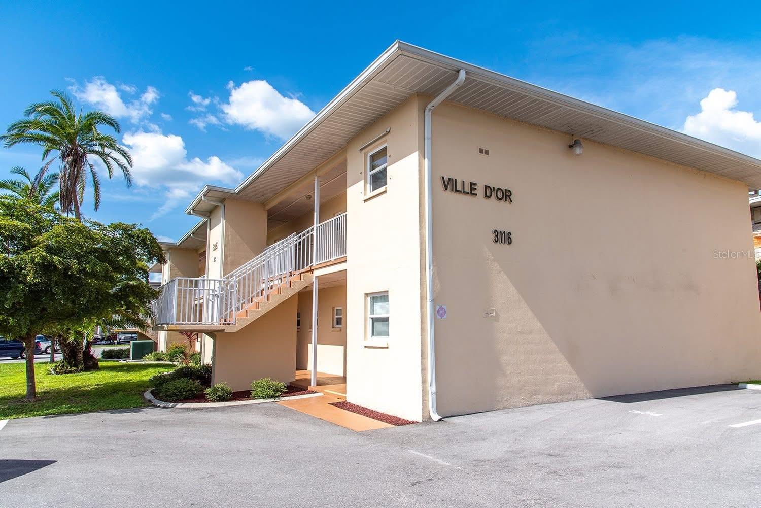 This spacious 2nd floor unit in Ville d’or condominiums features a large master bedroom with ensuite and walk in closet, solid surface countertops, and ceramic tile throughout. Enjoy the versatility of a bonus Florida room perfect for a home office or additional living space. The unit overlooks a beautifully landscaped courtyard and tranquil canal, offering serene views. Ideally located in the heart of Port Charlotte, you are a short walk from the promenades mall, shopping, banks, medical offices, a bowling alley, hospitals and more. This is Florida living with unbeatable convenience, schedule your private showing today!