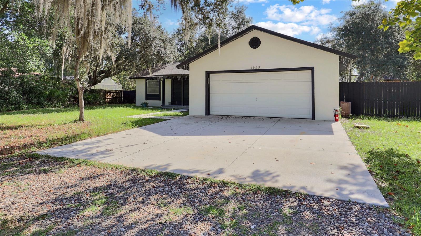 Located just minutes from UCF and local shopping, this 3-bedroom, 2-bath home offers a perfect mix of comfort and convenience. Inside, you’ll find an updated kitchen with granite countertops, durable vinyl and tile flooring, and spacious bedrooms with plenty of natural light. The large fenced yard features a double-wide gate, perfect for storing boats, RVs, or ATVs, along with ample parking for guests or extra vehicles. Whether you're looking for a personal residence or investment, this Oviedo gem is move-in ready and full of potential.