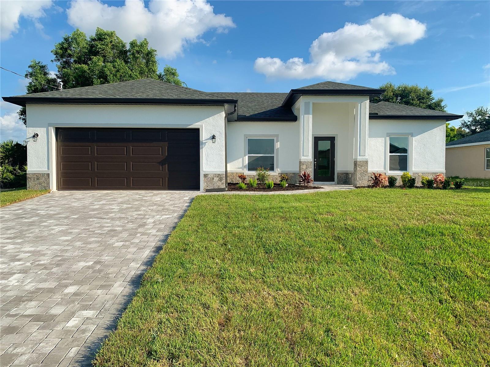 NEW CONSTRUCTION - MOVE IN READY !! Beautiful split floor plan with Impact windows and doors. Includes full 1-year warranty and 10-year structural warranty! Prime location, very easy access to I-75, shopping and dining. Enjoy a peaceful backyard view with mature trees. Open layout, high tray ceilings, and elegant Porcelain Tiles throughout. The spacious kitchen is equipped with 42" upper cabinets, a pantry closet, and premium granite countertops. The bright living area opens to a generous covered lanai. The Master features TWO walk-in closets and a gorgeous bathroom. Additional features: Decorative impact glass front door, extra linen closets, high-efficiency AC system, Moen shower valves, and dimensional roof shingles. Great outdoor area with upgraded Landscaping and Irrigation system. The front is tastefully finished with natural looking Stones and Brick Paver driveway. Images may be from similar homes. Great opportunity to own a brand new home loaded with upgrades!
