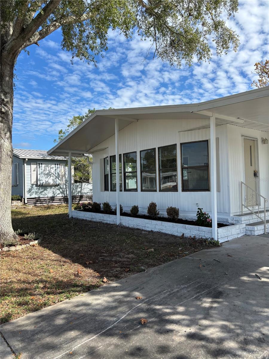 WELCOME HOME -- This newly renovated 2/2 home is ready for it's new owner. Freshly painted inside and out. BRAND NEW luxury vinyl flooring throughout the 1328 sqft of living space. BRAND NEW KITCHEN -- new cabinets, granite countertops, new stainless steel appliances, new tiled backsplash, stainless steel sink; featuring, a center island with additional storage! Large eating area just off the kitchen. Newer fans/fixtures throughout. SELLER INTENDS TO INSTALL BRAND NEW CENTRAL HVAC SYSTEM PRIOR TO CLOSING. Large, covered, side-porch. Laundry hookups are located inside the storage area. Nice yard with no rear neighbor. Covered carport. Located inside the active community of Brookridge which features a community center, community pool, golfing and much more. Low HOA fees, no land rent. You own your land! Make an appointment to view this one today before it's gone!