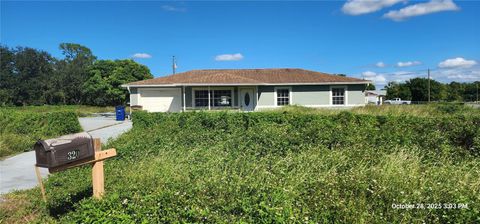 Photo of 320 Plumosa Avenue, Lehigh Acres, FL 33936 (MLS # TB8445066)