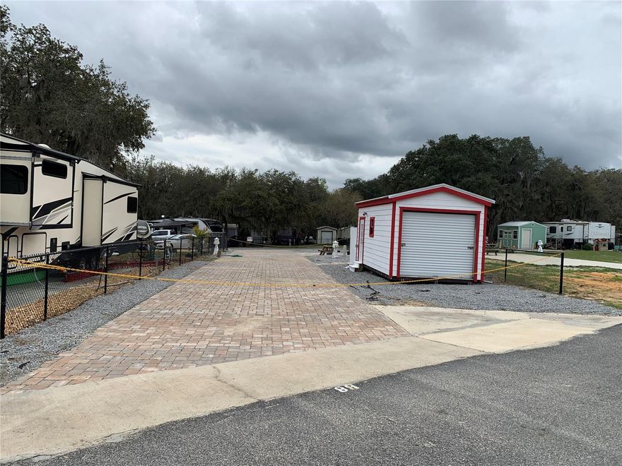 TWO DRIVE THROUGH deeded lots ~ including paver driveway, fence on each side, 10x20 shed with private outdoor shower and indoor toilet. This property is a great family retreat ~ multi family ~ investment property for AirBnB/Vrbo ~ with 2 lots, there is plenty of room for RVs. Amenities for all ages include a pool, clubhouse, dog park, beach area, playground, corn hole, volleyball, ATV riding trails, nature trails to lake and outlook, and much more. Close to downtown Fort McCoy with grocery store, doctor's office, pharmacy, hardware, gas station, pizza delivery and 30 miles to Ocala's conveniences. For the outdoor enthusiast, lakes, springs, and Ocala National Forest are close by for you to enjoy fishing, hunting, hiking, boating/canoeing/kayaking, and ATV trails! HOA includes electric, water, sewer, and trash. See attachments for more info.