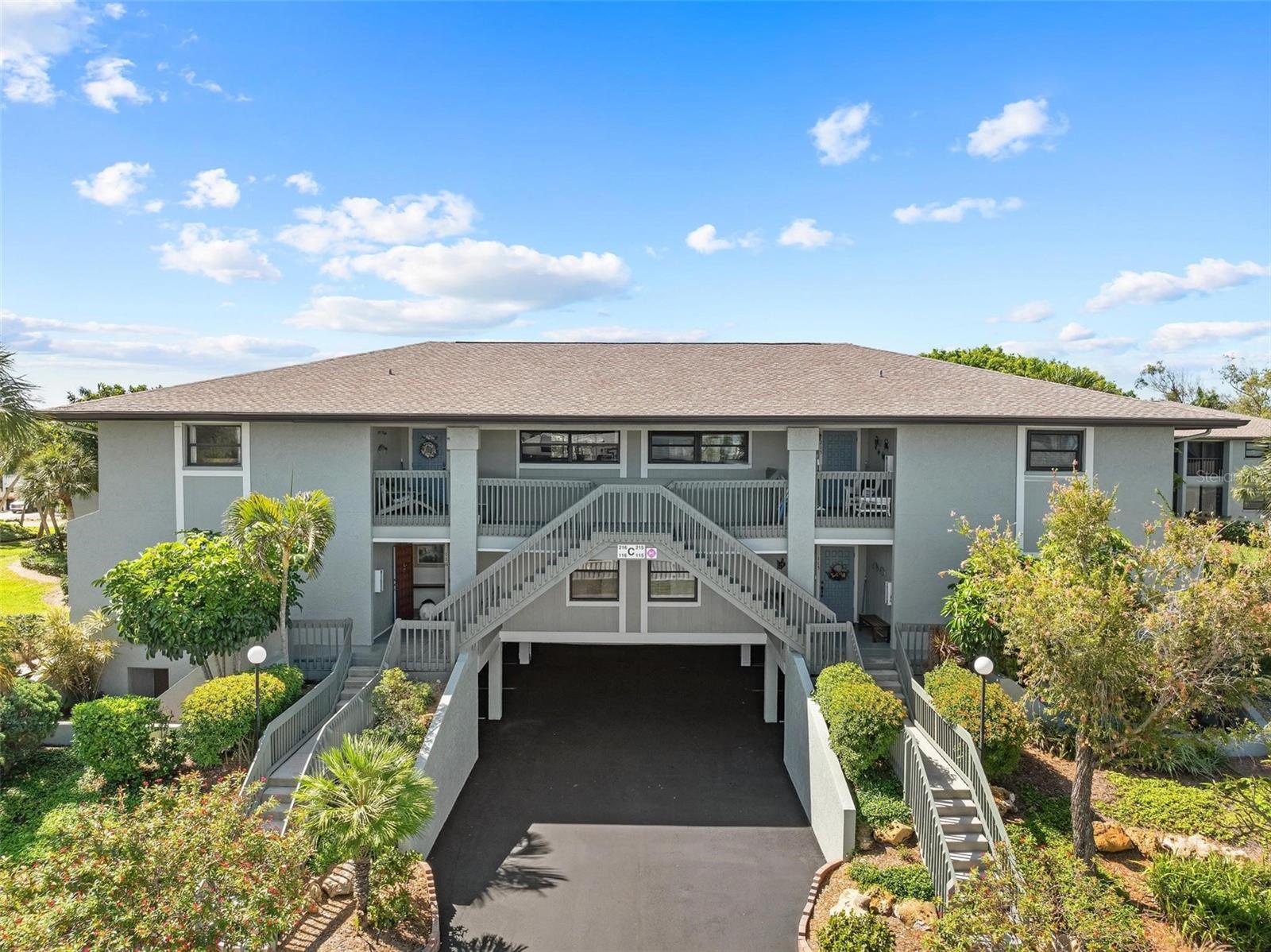 Welcome to this freshly remodeled, elevated two-bedroom, two-bathroom end-unit condo at Island Village in Holmes Beach—perfectly located just one block from the pristine sands of Anna Maria Island. This bright and airy second-floor condo has been thoughtfully updated and sustained no damage in the recent storms. It includes two dedicated parking spaces and a storage area, offering both comfort and convenience. Inside, the home has been freshly painted with new tile floors in the kitchen and lanai featuring a clean, modern aesthetic. One of the standout upgrades is the enclosed lanai, now fully under air with the recent extension of the A/C system. This sun-filled retreat is enhanced with a wall of sliding glass doors and Phifer weave sunscreen shades, offering serene views of the lush, park-like surroundings. The kitchen is designed with both style and functionality in mind, featuring durable Corian countertops, a breakfast bar, a Whirlpool full-size stainless-steel refrigerator and freezer, and custom Kitchen Craftmade Cabinetry with a pull-out pantry for organized storage. The spacious primary bedroom includes sliding glass doors that open to the lanai, a large walk-in closet, and an en-suite bathroom. The second bedroom offers its own private bath, making it ideal for guests or family members. A dedicated laundry room with a full-size washer and dryer adds everyday convenience to this well-appointed home. Recent updates include a new roof in 2025, an upgraded electric meter in 2024, a newer A/C system that now extends to the lanai, and a refreshed exterior paint job also completed in 2021. The home also includes an osmosis water filtration system. This condo is part of Island Village, a well-maintained, maintenance-free community where the HOA covers cable TV, internet, water, sewer, trash, insurance, and upkeep of the grounds, exterior, community pools, and tennis courts. Residents enjoy access to two heated pools and two tennis/pickleball courts, offering ample recreational opportunities year-round. Located just across from St. Bernard’s and only two blocks to beach access, this home is ideally positioned within easy access to over 20 public beach access points, 12 parks, popular restaurants, and local shops. The FREE Holmes Beach Trolley stops right in front of the community, making it easy to explore the island without the hassle of driving. Don’t miss this rare opportunity to own a beautifully updated condo in one of Anna Maria Island’s most desirable communities. Schedule your tour today and experience the relaxed, tropical lifestyle of Island Village.