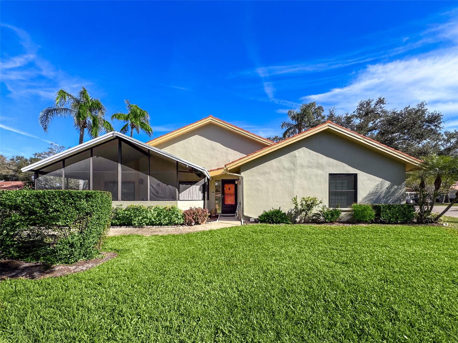 Welcome to effortless living in the heart of Clearwater, Florida. 2281 Lake Arbor Blvd is a single story, end unit villa with covered parking, updated and move-in ready, nestled in the desirable, pet friendly Villas of Lake Arbor—a serene and meticulously landscaped 55+ community with LOW HOA fees and solid reserves. The living area features soaring ceilings and a cheerful ambiance, ideal for both relaxing and entertaining. The primary suite is a peaceful retreat with a walk-in closet and a renovated, oversized shower with modern lighting. Bright Florida room with climate control and an expansive private patio are perfect for enjoying Florida's sunshine. For quiet evenings, unwind on the 22-foot screened porch with a hot tub, surrounded by lush landscaping that offers ultimate privacy. The updated kitchen is a culinary delight, boasting sleek soft-close cabinetry, granite countertops, and ample prep space. It’s equipped with modern appliances. The inside laundry room comes with a newer washer and dryer for added convenience. Additional upgrades include hurricane-rated windows and doors, newer ICP air conditioning system with Reme Halo air purification and exterior dusk-to-dawn lighting for added safety. Zone X – No flood insurance required, no evacuation zone and no history of storm damage! Community amenities elevate your lifestyle with a lakefront heated pool, clubhouse, outdoor cooking area, fishing dock, kayak storage, and exotic mature landscaping. Monthly HOA dues cover cable, internet, trash, road maintenance, grounds care, and pool access—ensuring a truly maintenance-free experience.