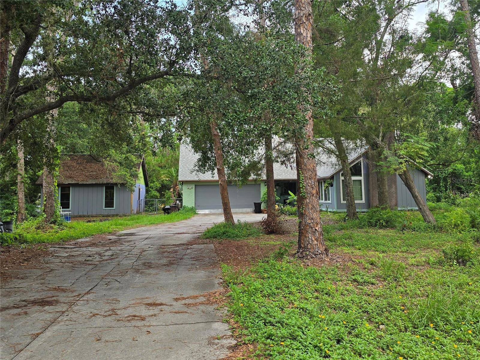 Renovate the existing home or start fresh! Discover a rare gem in Sarasota’s Hidden Forest neighborhood! This spacious 2,832 sq. ft., 4-bedroom, 3-bathroom single-family home sits on a serene 1-acre lot with no deed restrictions, HOA, or CDD fees, offering unparalleled freedom to make it your own. Built in 1977, this property features a caged in-ground pool with a large screened-in patio and deck, perfect for relaxation or entertaining. A detached artist studio provides versatile space for a home office, guest quarters, or creative retreat. The home also includes a den, cathedral and vaulted ceilings, ceiling fans, and a master bedroom on the main floor. Appliances include an electric water heater, range, refrigerator, and washer. The roof was newly installed in November 2023, ensuring peace of mind for years to come. Nestled in a tranquil, outdoor enthusiast-friendly neighborhood, this home is conveniently located near Detwiler’s Farm Market, University Town Center, and I-75, with downtown Sarasota just over 5 miles away and Siesta Key/Lido Key beaches within a 30-minute drive. This property offers a unique opportunity for transformation, ready for your personal touch to create your dream home. Don’t miss out on this one-of-a-kind Sarasota retreat—schedule your private tour today!