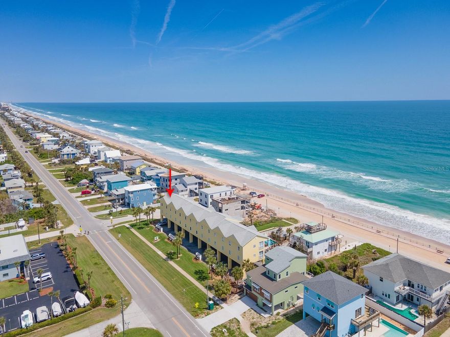 Introducing 6612 S Atlantic Ave — a beautifully renovated beachside coastal condo just steps from the sandy shores of New Smyrna Beach’s desirable no-drive beach. Step inside and immediately be captivated by four expansive floor-to-ceiling sliding glass doors showcasing breathtaking OCEAN VIEWS and endless bluebird skies. The seamless indoor-outdoor living leads to your private balcony, where you can enjoy morning coffee, evening wine, stunning sunrises, and even rocket launches from Cape Canaveral just 30 miles to the south. This top-floor corner end unit is offered FULLY FURNISHED and truly turnkey, providing everything needed for effortless beachside living. High ceilings and an open dining area flow into the renovated, fully equipped kitchen. Recent upgrades include NEW APPLIANCES and HVAC in 2024, along with hurricane-impact windows and turtle-friendly glass installed in 2023. The primary suite features an en-suite bath, while both bedrooms enjoy peaceful views overlooking Mosquito Lagoon. A conveniently tucked-away washer and dryer add to the ease and comfort of everyday living. Two private covered, assigned parking spaces are included, along with convenient beach parking located directly along the seawall. Ocean Club at Turtlemound is pet-friendly, and the HOA fee includes a private, fenced POOL and cabana, outdoor grill, cable, internet, and water. An added bonus — the seawall is maintained by the county, not the HOA. Perfectly situated between the Atlantic Ocean and Mosquito Lagoon, this exceptional location offers endless outdoor recreation including kayaking, fishing, surfing, paddleboarding, and boating. Walk to historic JB’s Fish Camp for waterfront dining and manatee sightings, or enjoy nearby Bethune Park featuring pickleball, tennis, basketball courts, a dog park, playground, picnic areas, and a fishing pier. For buyers seeking an investment opportunity or second home, this property also offers excellent short-term rental potential to help offset ownership costs. Just pack your toothbrush — this fully furnished coastal retreat, including TVs, is completely MOVE-IN READY. Don’t miss the opportunity to own your own slice of paradise where coastal elegance meets laid-back beachside living.
