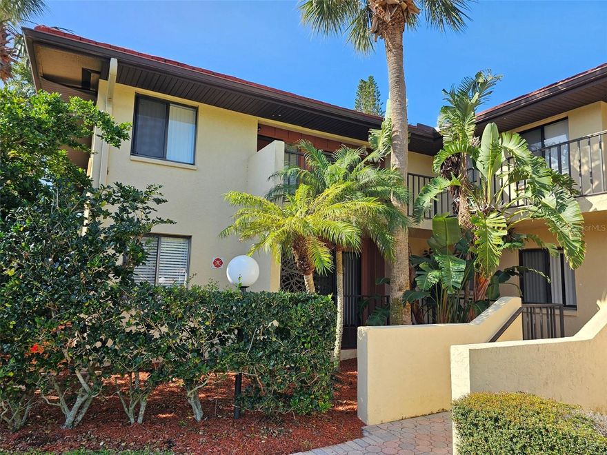 Welcome to your peaceful escape in Wild Oak Bay! This fully furnished, end-unit residence offers two bedrooms and two baths on the second floor—accessible by stairs only to ensure maximum privacy and tranquility. Step inside to an open living and dining area, where abundant natural light and comfortable seating create an ideal spot for relaxing or entertaining. The adjacent kitchen is exceptionally well-appointed, with everything you need to whip up a quick breakfast or host a dinner party. Just off the main living space, the air-conditioned Florida room overlooks the pond, heated pool, and hot tub. Whether you’re savouring your morning coffee or winding down with a book at sunset, this serene sunroom feels like an extension of your living area. Practical touches abound, including a discreet laundry closet tucked into the kitchen for easy upkeep. When it’s time to retire, you’ll find two comfortable retreats: Primary Suite: King-size bed, a walk-in closet, and direct access to the Florida room. The en-suite bathroom features a spacious walk-in shower and plenty of storage. Guest Bedroom: Queen-size bed, thoughtfully furnished for comfort, with a nearby full bath boasting a tub/shower combination. Located just minutes from IMG Academy, the State College of Florida, shopping and dining, and our stunning Gulf Coast beaches, this home blends convenience with a laid-back Florida lifestyle. Book your stay today and experience Wild Oak Bay living at its finest!