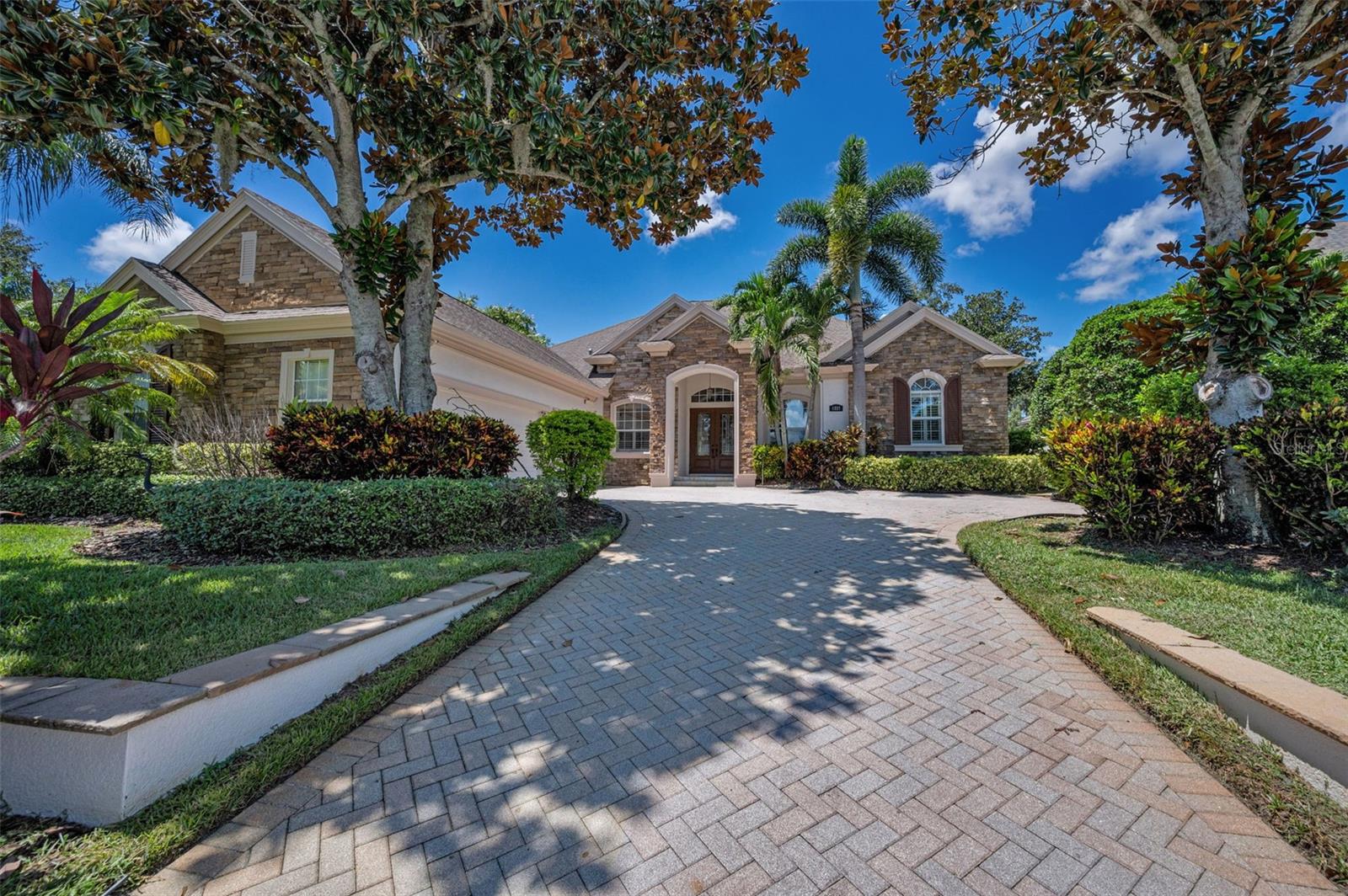 Luxury resort-style living awaits at The Champions Club. Situated on the 11th fairway of the renowned Fox Hollow Golf Course, this exceptional custom-built pool home offers nearly 4,000 square feet of elegant living space on a premium 1/3-acre lot in one of Trinity’s most sought-after gated communities. This meticulously maintained residence features 4 bedrooms, an office, an upstairs bonus room (which can serve as a 5th bedroom or in-law suite), 4.5 bathrooms, and an oversized 3-car courtyard garage. From the moment you arrive, the beautiful curb appeal, upgraded landscaping, and extra-long paver driveway set the tone for what’s inside.
Upon entering through double doors, you’re welcomed by an open and spacious floor plan filled with natural light. Details such as crown molding, 18x18 tile flooring, 8-foot interior doors, upgraded lighting, and plantation shutters throughout elevate the home’s elegance. The gourmet eat-in kitchen is a chef’s dream, complete with 42-inch wood cabinetry, granite countertops, a large center island, breakfast bar, tiled backsplash, stainless steel appliances, gas cooktop, and double wall ovens. Adjacent to the kitchen, the formal dining area and family room with sliding doors open to the expansive travertine lanai—an entertainer’s paradise.
Step outside and enjoy the incredible outdoor living space featuring a stunning saltwater pool with waterfall spa, open-air lounging areas, and breathtaking views of the golf course and sunset skies. The private primary suite offers direct lanai access, two custom walk-in closets, and a spa-like en-suite bathroom with granite counters, dual sinks, a garden tub, walk-in shower, and decorative listello tile accents. The upstairs bonus room includes its own full bathroom and oversized closet, making it perfect for guests, a media room, or multi-generational living.
Additional upgrades include a central vacuum system, freshly painted interior and exterior, inside laundry room, pool bath, new exterior paint, 16 newer windows, and a new pool motor. This immaculate home is move-in ready and perfectly positioned near Champions Club’s exclusive amenities. Residents enjoy access to a private clubhouse, heated pool and spa, fitness center, massage area, tennis courts, and frequent social events. Located near top-rated Trinity schools, shopping, dining, medical facilities, and the Veterans Expressway, this is luxury living at its finest. Don't miss this opportunity to own a truly exceptional home in Champions Club. Schedule your private showing today.
________________________________________