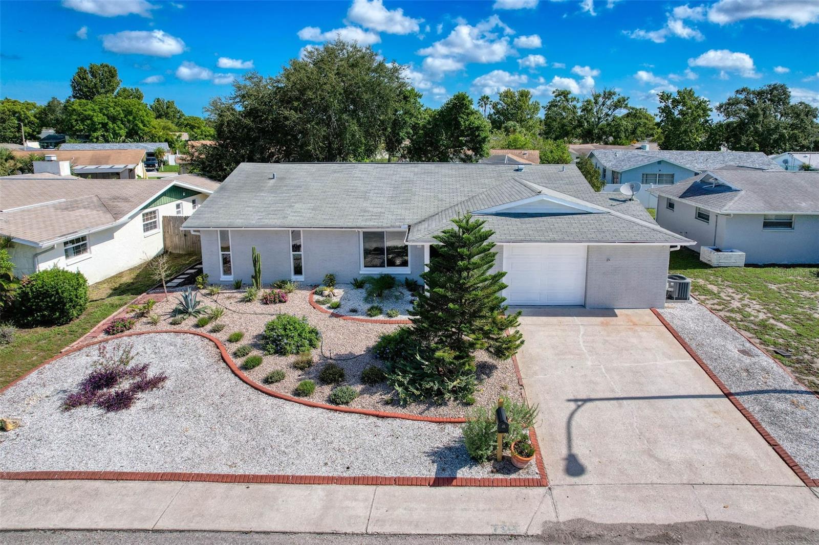 POOL HOME! Welcome to 7311 San Carlos Drive, a beautifully reimagined residence nestled in the heart of Port Richey. This elegant 3-bedroom, 2-bathroom home offers 1,364 square feet of open and thoughtfully updated living space, blending timeless charm with modern sophistication. Step inside to find brand-new flooring throughout and a light-filled, open layout that effortlessly connects the living areas. The completely updated kitchen is a true standout designed with sleek cabinetry, stylish countertops and backsplash, and new stainless steel appliances, perfect for both daily living and entertaining. Every detail has been carefully considered, from the impact windows for enhanced safety and efficiency, to the newer HVAC system providing year-round comfort. Step outdoors to a freshly resurfaced private pool that invites you to relax and unwind in the privacy of a fully fenced backyard. Additional features include an oversized one-car garage with laundry and workshop area, a covered front porch and a screened in lanai. Ideally situated near Lake Lisa Park, schools, shopping, dining, and just a short drive to the Gulf Coast, this move-in-ready home offers the perfect blend of comfort, convenience, and coastal living.
