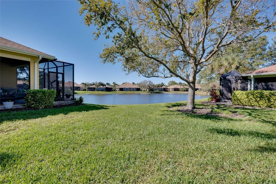This beautifully appointed 4-bedroom villa is located in the highly sought-after Palma Sola Trace community, just under four miles from the area’s stunning Gulf beaches. Thoughtfully designed with both style and comfort in mind, the home features soaring ceilings, 8-foot doors, Andersen impact-resistant windows, tray ceilings, crown molding, French doors, surround sound, and a screened lanai—perfect for embracing Florida’s indoor-outdoor lifestyle.  The spacious, open floor plan offers excellent bedroom separation, highlighted by a private split primary suite measuring 17’ x 13’, complete with a walk-in closet and dual vanities. An oversized laundry room adds everyday convenience with upper and lower cabinetry, a utility sink, and a luggage shelf. The two-car garage is equipped with overhead storage racks for added organization.    The spacious open floor plan and generously sized rooms create a sense of space that lives much larger than its nearly 2,000 square feet.  Situated on a premium homesite overlooking a tranquil pond, this villa enjoys additional privacy and space between neighboring homes and is just a short walk to the community clubhouse. Palma Sola Trace is a maintenance-free community, with lawn and landscape care included, as well as a new roof and exterior paint completed last year.  Residents enjoy resort-style amenities, including a spacious clubhouse with gathering room and catering kitchen, fitness center, heated pool, covered patio, sun deck, playground, and scenic walking paths. Ideally located near shopping, dining, and everyday conveniences, this home is also just minutes from the sugar-sand beaches of Anna Maria Island—offering the best of coastal Florida living.
