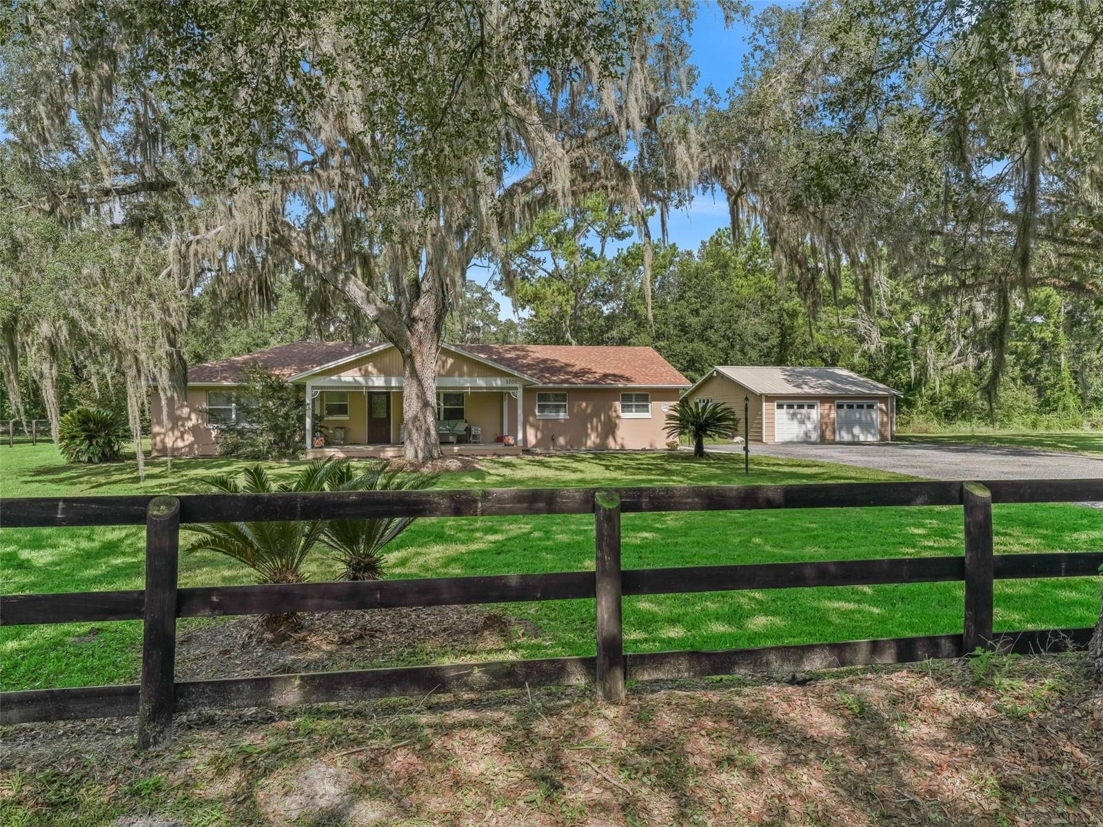 Location, Location, only 10 Minutes from the World Equestrian Center. Beautifully updated 3-bedroom, 3-bath home situated on nearly 2.5 acres with grand live oak trees and a fully fenced pasture—perfect for a mini farm or equestrian lifestyle. The spacious, split-bedroom floor plan includes a newly converted 24x24 primary suite featuring a luxurious en-suite bathroom with walk-in shower and soaking tub. The home has been fully updated throughout, including a new roof in 2021, and offers modern finishes and thoughtful design. Outside, enjoy a large front porch, a screened-in back patio and a brand-new hot tub—ideal for relaxing after a long day. There’s plenty of space for vehicles and storage with a 3-car garage, carport, and shed. The property offers privacy, flexibility, and country charm with quick access to world-class equestrian facilities. Don’t miss the opportunity to own this turnkey homestead just minutes from WEC.