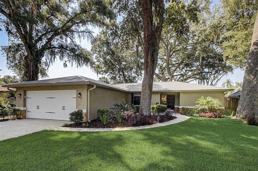 Discover your perfect haven – it's finally here! Immerse yourself in a tranquil oasis within a charming and intimate neighborhood. The ideal blend of serenity and convenience, with absolutely NO deed restrictions or community fees. This is the opportunity you've been waiting for, where your boat, mobile home, or commercial vehicle is more than welcome. Step into a MUST-SEE 3-bedroom, 2-bathroom residence that exudes care and maintenance. The allure of a splendid backyard awaits, nestled in the quiet embrace of a cul-de-sac within a close-knit community boasting impeccably kept homes. A generous layout encompasses a formal living room (currently a piano bar), a dining room perfect for cherished gatherings, and an open family room featuring an upgraded wood-burning fireplace. The kitchen transformed in 2019 has an array of enhancements. Open concept as walls were removed and resplendent canned lighting now graces the room. High-end appliances, including a refrigerator, induction cooktop, oven, microwave, and garbage disposal - elevate the culinary experience. An expansive 8-foot island, enveloped with storage in the form of drawers and cabinets, takes center stage, accompanied by sleek quartz countertops. Delight in a pass-through window that seamlessly connects indoor and outdoor spaces with matching quartz. Revel in privacy with a split bedroom arrangement. The opulent master suite boasts an extensive walk-in closet and a master bath adorned with dual sinks and sliders to screened lanai. The fully fenced yard presents a lush, enchanting lawn, several shady oak trees and a grand oak the help reduce cooling utilities, along with a screened lanai and deck – an idyllic backdrop for gatherings or personal relaxation. Recent enhancements by the sellers, including: 2019 - metal roof,  2019 – replaced all duct work, 2017 - replaced rear property line fence, 2019 - replaced outside deck, 2019 - new impact resistant garage door, 2020 - garage door opener replaced, 2021 - new A/C system installed (outside and inside handler), 2021 - front landscaping redone to include paver walkway from driveway to front door,  2022 - electrical panel updated from 150 to 225. Close to all the essential amenities, shopping and dining options are within reach, and about 7 miles to Raymond James and less than 10 miles to downtown Tampa. Yet, revel in the privilege of returning to your peaceful retreat. Seize the opportunity to embrace a lifestyle that encapsulates both convenience and tranquility – this is the remarkable place you'll be proud to call HOME.