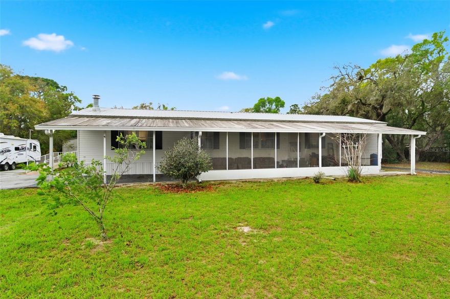 WELCOME TO YOUR PEACEFUL COUNTRY RETREAT at 9634 Pat St, Hudson, FL in Pasco County. This 1999 manufactured home with nearly 1,800 sqft features 3 bedrooms, 2 bathrooms & sits on LEVEL, USABLE LAND with NO HOA, NO CDD & NO FLOOD ZONE - giving you the flexibility to truly live the lifestyle you’ve been dreaming of. Tucked away in a QUIET, RURAL setting, this property welcomes you with a LONG U-SHAPED DRIVEWAY that extends deep into the land, providing EASY ACCESS, extra privacy, and AMPLE parking for multiple vehicles, work trucks, trailers, boats or recreational toys. In addition to the home, you’ll appreciate the DETACHED GARAGE and MULTIPLE CARPORTS - perfect for storage, hobbies, or protecting your equipment. Step inside and feel right at home in the SPACIOUS, OPEN living areas designed for comfort and functionality. The open floor plan consists of the kitchen, dinette, family, dining & living rooms. The wood burning FIREPLACE with STONE wall & hearth & thick wood mantle serves as the focal point of the family room, creating the perfect atmosphere for relaxing evenings and gathering with family and friends. The kitchen features a 4-door French fridge, range, microwave, disposal & space for a dishwasher. More wonderful features in the kitchen are breakfast bar/center island, expansive laminate counters with tiled edges, tiled backsplash, cabinets with artistic knobs, crown molding, built-in desk & walk-in pantry located in the laundry room. The dining room is currently used as the home office while the living room is another place to relax. The HUGE PRIMARY BEDROOM can easily accommodate king-size furniture & has an en-suite. The private bathroom consists of dual sinks, built-in desk/make-up center, walk-in closet, garden tub, separate shower with dual shower heads, built-in benches & safety grip handles & private toilet room. In this split bedroom plan, the additional bedrooms are generously sized and versatile for family, guests or flex space. The second full bathroom has a step-in shower with glass enclosure, cabinet vanity with storage, medicine cabinet & newer toilet. Enjoy the MASSIVE screened & covered Florida room overlooking the front yard or hang out on the expansive wood deck in the back yard. The roof, water heater & AC are all newer. ENJOY COUNTRY LIVING at its best with room to roam, garden, expand, or simply unwind under wide open skies. Bring your animals - dogs, cats, chickens, goats & maybe even a horse to live with you on this BEAUTIFUL 1.033 ACRE or 45,000 sqft parcel (150' x 301' dimensions) where space, freedom, and rural charm come together! In addition to the detached garage, 1-carport attached to the home, another 2-vehicle carport & multiple sheds, there is a 1973 single wide of length 61 feet located on this property that is currently being used only as storage. Condition of this single wide is unknown. Renovate this single-wide & create MULTI-GENERATIONAL LIVING or utilize it as an investment property. The possibilities are endless for creating your own homestead, workshop area or outdoor oasis. If you have been searching for AFFORDABLE SPACE, PRIVACY & FREEDOM without restrictions, this is your opportunity to own a slice of the country while still being within reach of modern conveniences. Location is IDEAL near beaches, medical plazas, shopping, restaurants, places of worship & tourist attractions. MAKE THIS YOUR FUTURE HOME!