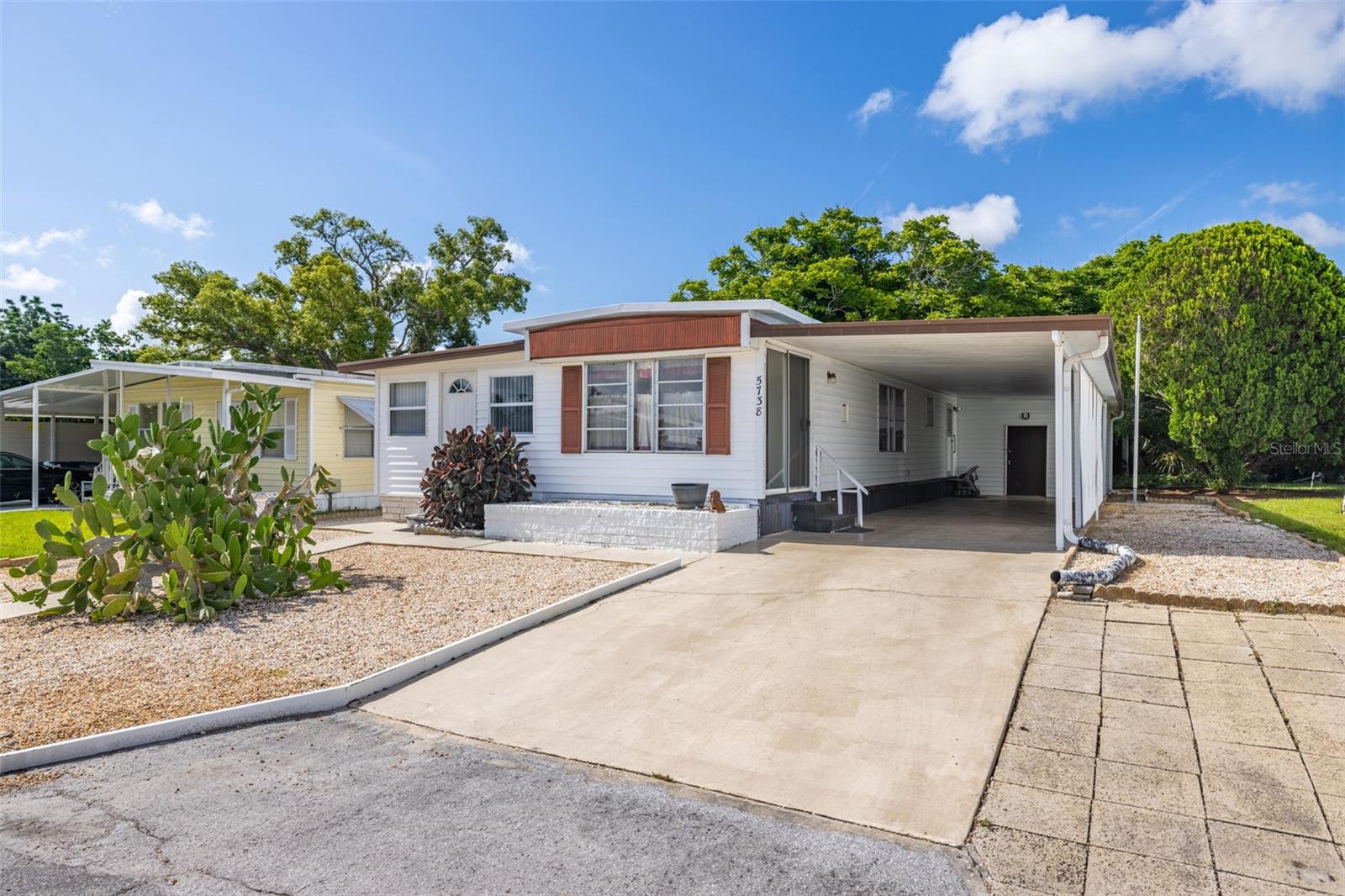 Great Location – Great Price! This 3-bedroom, 1-bath mobile home in the heart of New Port Richey is move-in ready and offers an unbeatable value—you own the land with NO lot rent and NO HOA dues! Enjoy peace of mind with a newer A/C system and new luxury vinyl flooring throughout. The home features three bedrooms, ideal for guests as well as a home office/flex space. The spacious kitchen includes an eat-in area and built-in cabinetry for ample storage. High and dry with no damage from the 2024 storms, this property is perfectly situated near charming downtown New Port Richey, medical centers, restaurants, and just 35 minutes to Tampa International Airport. Ideal as a year-round residence or seasonal getaway, with an optional HOA of just $35 per year. Schedule your private showing today!