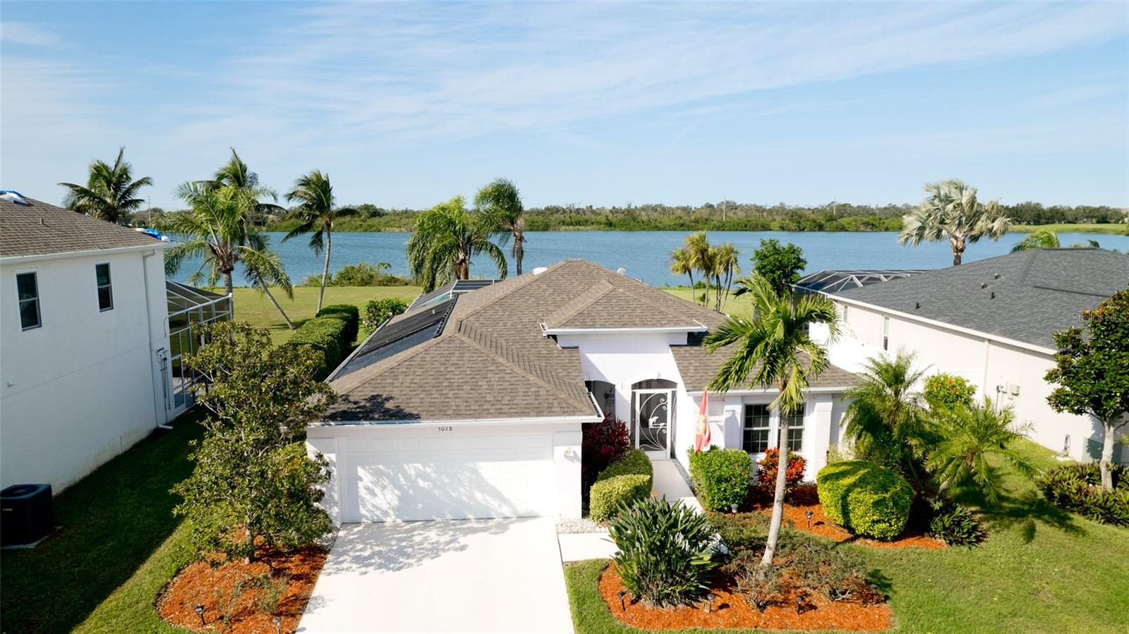 Are you looking for a "little piece of paradise"? This lovingly maintained and updated one owner pool home on the "Big Lake" may be the perfect choice! When you step into this 3 bedroom/2 bath home, you'll be welcomed by a breathtaking pool and wide lake view thru oversized living room windows and dining room sliding glass doors. The open floor plan of kitchen, dining and living rooms helps this home live larger than its actual square footage and is ideal for entertaining. There is a split bedroom plan, with the guest bedroom wing on one side of the house and the primary bedroom on the other. The primary bedroom has a deep walk-in closet and ensuite bathroom with dual sinks and walk-in shower. The bedroom also has direct access to the exterior pool area. Whether you sip a cup of coffee on the cozy front screened porch, watching the sunrise, or watch the Florida sun sink in the West from the spacious pool area, you will have glorious skies and water reflections as your everchanging landscape. The caged and resurfaced pool and spa can be heated by gas or solar. There is a child safety fence for pets and loved ones. The pool deck has been enlarged for entertaining and offers sweeping lake views. The property has been improved through the years and includes an 8-year-old roof, newer quieter pool pump, hurricane proof windows, sliding glass doors, and lanai storm screen, 2023 air conditioner and newer appliances. The attractive, luxury vinyl laminate floors in the guest wing are new this year! Glenn Lakes is a popular subdivision in the heart of West Bradenton. It is near IMG Sports Complex, the new Detweiler's Farm Market, great restaurants, movies, bowling, mini golf and shopping. The Sarasota Bradenton International Airport and University Town Center Mall are an easy drive away, as are the amazing Performing Arts Centers of both Bradenton and Sarasota. And... the sugar sand Gulf Beaches, restaurants, shopping, spectacular sunsets and water activities on quaint Anna Maria Island? Just a handy drive away! This is your rare opportunity to own a beautifully landscaped, West facing Glenn Lakes home on the Big Lake. Visit it soon before it's gone!