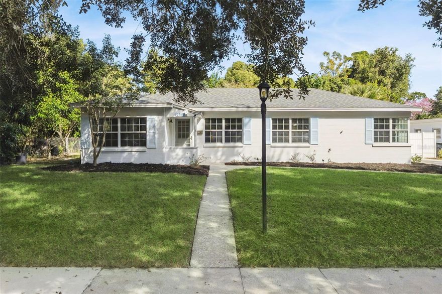 One or more photo(s) has been virtually staged. Live the Winter Park dream in this freshly updated 3-bedroom, 2-bath home—just steps from Lake Killarney and minutes to I-4, boutique shopping, and top dining spots. The interior has been freshly painted, creating a bright and welcoming feel throughout. The updated kitchen shines with white shaker cabinets, quartz countertops, a subway-tile backsplash, and stainless-steel appliances. It’s perfect for everyday cooking and effortless entertaining. Wood-look laminate floors flow through the spacious living and dining rooms and into the bedrooms, while the family room offers wood-look tile, a cozy fireplace, and sliding doors that open to the screened patio. Outside, a long driveway extends beyond the fenced yard to a side-entry oversized two-car garage with workshop area. Surrounded by mature trees, the backyard is a private retreat with a cozy firepit, utility shed, and a versatile concrete pad—ideal for basketball games or weekend gatherings under the stars. Zoned R-1A, the property also allows for an accessory structure such as a guest suite or studio (no kitchen permitted) Thoughtful updates, generous outdoor space, and an unbeatable location near Lake Killarney make this home a rare find. Come experience comfort, character, and convenience in the heart of Winter Park.