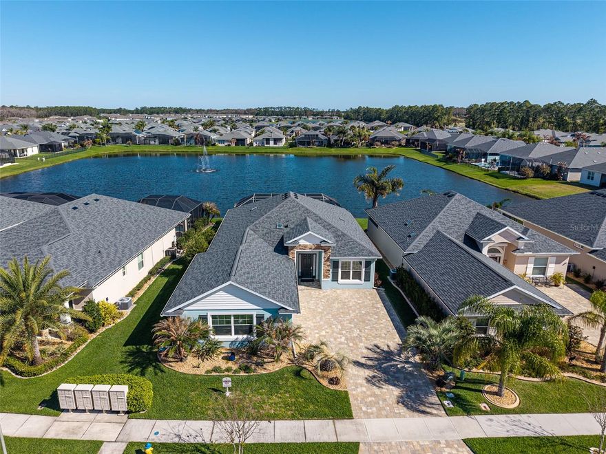 Step into a world of thoughtful beauty in this custom waterfront pool home located in The Palms within Venetian Bay! The architectural appeal is undeniable in a home where every detail has been meticulously curated for a sophisticated coastal vibe. Interior Excellence shows with the seamless wood-look LVP flooring throughout and elegant crown molding flowing through the residence. The heart of the home is a light-drenched great room featuring a dramatic coffered ceiling and a wall of windows that frame the pool and expansive water views with fountain. The gourmet kitchen is a showstopper boasting pristine white quartz countertops, custom cabinetry and hardware with oversized drawers for maximum storage, stainless steel appliance and an oversized island accented with designer wainscoting. The primary en-suite also features a tray ceiling, walk-in closet, double vanity and an extended walk-in shower. Three additional bedrooms offer plenty of room for family and guests. Even the chores are elevated in the dedicated laundry room, fully equipped with custom upper cabinets and sink. The living space extends outdoors to a beautiful pool with a raised spa and paver deck overlooking expansive lake views. Enjoy resort-style living in Venetian Bay, featuring a Golf & Country Club, scenic walking trails, and a vibrant Town Center with a world-class spa, trendy restaurants, BREW coffee shop, salon, and fitness center. The community hosts Food Truck Mondays, Farmers Market Tuesdays, concerts in the park, and offers miles of bike trails and Pickleball Courts. Call today to schedule your private showing! All sizes approximate. All information deemed accurate but not guaranteed.