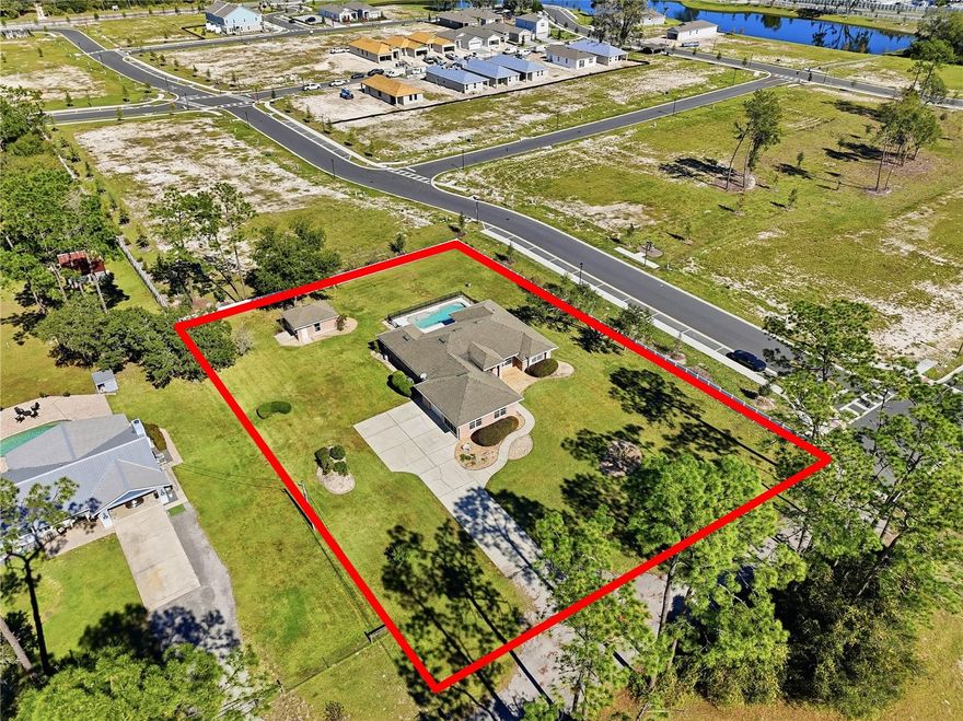 MAJOR PRICE IMPROVEMENT – MOTIVATED SELLER! This is your opportunity to own a truly RARE property: discover the perfect blend of space, comfort, and convenience with this stunning 4-bedroom, 3-bath pool home sitting on **a full acre right in the heart of the city**! Featuring **vaulted ceilings**, a bright open layout, and a **split bedroom floor plan**, this home is designed for both everyday living and effortless entertaining. Step outside to your **screened-in pool with a separate jacuzzi/hot tub**, all overlooking a **beautifully fenced backyard with plenty of open grassy space**. Inside, you’ll find **granite countertops, solid wood cabinets, upgraded custom appliances, tile floors**, and a spacious **master suite with a large bathroom** and direct views of the pool. The **fourth guest bedroom features its own bathroom with direct access to the pool**, making it perfect for visitors or an ideal in-law or guest suite. Need extra space? The property includes a **separate powered workshop/office/storage building**—ideal for projects, business, or additional storage. A dedicated laundry room and water treatment system add to the home’s convenience and value. All of this on **one acre**, close to shopping, restaurants, and I-4. Homes like this rarely come available—**come make this exceptional property yours!** **All dimensions, room sizes, and measurements are to be verified by the buyer.**