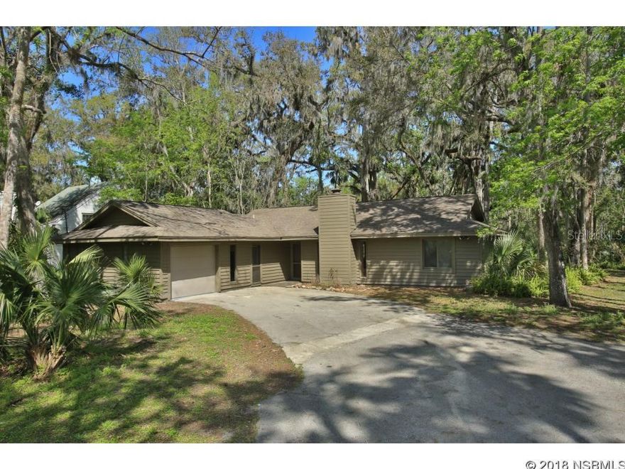 Centrally located, close to everything, yet it feels like you are far away from the hustle and bustle of the city. Paved street and city water, in neighborhood of nice homes all on estate size lots. Private back yard provides you with serene outdoor living space with towering oaks on this .82 acre lot. The rear screen porch will be your favorite place to be, as you unwind and leave your cares behind. Beamed, vaulted  ceiling in living/dining area  that features 20 inch tile floors and  is anchored by wood burning stone fireplace. Eat-in kitchen has pass through to screened porch. Interior A/C laundry room, hall bath completely redone, and master bath is updated with new tub and shower. Master features large walk-in closet. 4th bedroom is your flex-room, with its own entry, built-in bookcase and desk, and could nicely function as your family room or man cave. New garage door, New A/C in 2016, newer kitchen appliances and water heater. ;Water: City