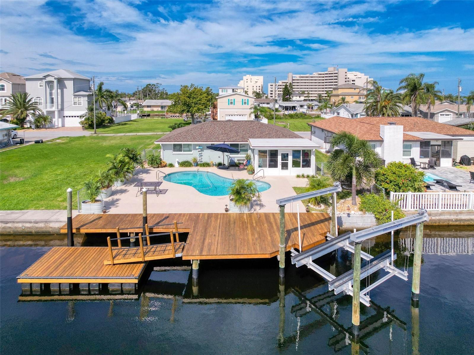 Welcome to your waterfront paradise! This fully furnished 3-bedroom, 2-bath home is a rare find, perfectly blending modern updates with the ultimate Florida lifestyle. Situated on a deep-water canal just 2 minutes to the open Gulf of America, this property is a boater’s dream, featuring a saltwater inground pool, floating dock, stationary dock, and 10,000 lb boat lift.
Step inside and you’ll immediately notice the light-filled open layout, updated with fresh interior doors, upgraded light fixtures, ceiling fans, and hurricane-rated windows throughout. The all-new kitchen shines with white shaker cabinets, Corian countertops, stylish tile backsplash, and a farmhouse sink—perfectly designed for both beauty and functionality.
The bedrooms are spacious and thoughtfully appointed, while the new bathrooms feature modern vanities, including a farmhouse sink and pedestal sink with upgraded fixtures. The home also offers the convenience of indoor laundry, a tankless water heater, and added attic insulation for efficiency.
Enjoy year-round relaxation in the new sun porch with hurricane-rated sliding windows and a seamless connection to the kitchen/dining area. Outside, the newer roof, newer A/C, resodded front yard, updated landscaping, sprinkler system, and freshly sealed pool deck and dock ensure peace of mind and easy living.
Located in a golf-cart friendly community, you’re just minutes from waterfront dining, the marina, and Hudson Beach. And best of all—the home is being sold fully furnished, decorated with professional flair and ready for you to move right in! Don’t miss this prime waterfront opportunity—schedule your private showing today!