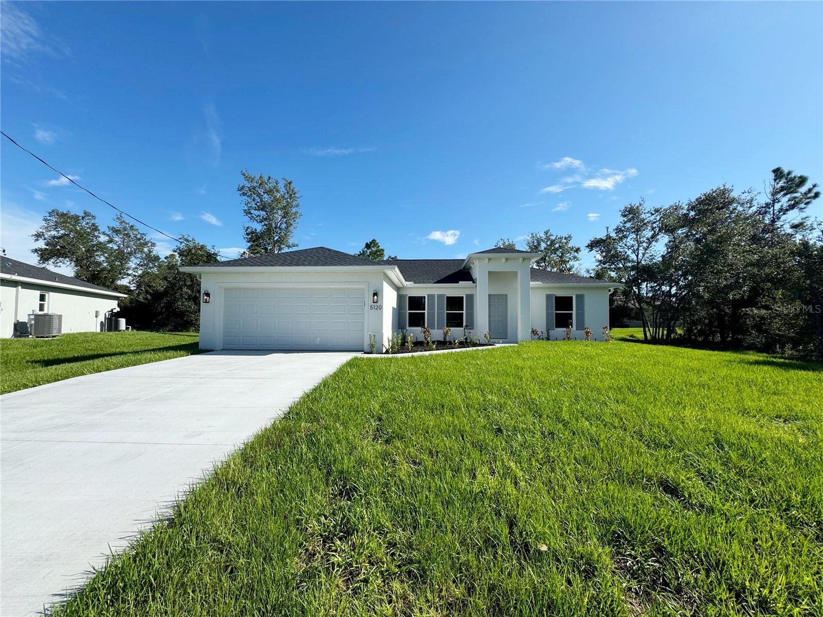 One or more photo(s) has been virtually staged. Beautiful New Construction Home Available Now on an Oversized Lot! Everything is Included and Everything is Upgraded! Starting with an open, split floor plan with vaulted ceilings, this home has Hurricane Impact, insulated, low e windows, full overlay cabinets, stainless steel kitchen appliances, quality stone countertops and window sills, porcelain tile throughout, 30-year shingles, 3 zone sprinkler system, screened lanai, brand name plumbing and electrical fixtures, fully sodded and landscaped. This home has been built to keep insurance, maintenance and utility costs low. Preferred lender is offering up to $1,500 in closing cost assistance! Take a tour through of one of our Beautiful Homes: https://youtu.be/SFsL-Aell24