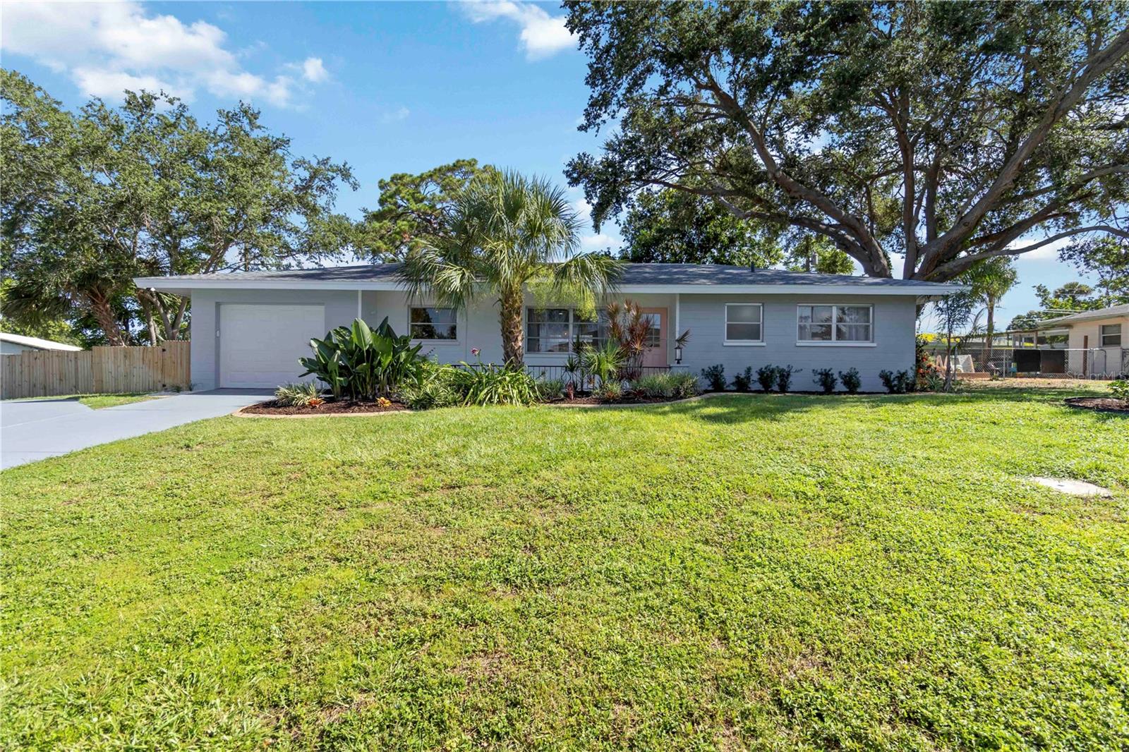 Welcome to this stunning, newly remodeled home on an oversized lot in the highly sought-after South Gate neighborhood in Sarasota. This professionally designed property boasts modern finishes and high end amenities throughout. Step inside to find an all new modern kitchen with custom tambour range hood, quartz countertops, two tone soft-close cabinets, under cabinet lighting, and all new appliances, including a higher-end fridge, stove, and microwave drawer. The kitchen also boasts a large island with pendant lighting and plenty of storage. The home features new luxury vinyl plank flooring throughout. All bathrooms have been updated with stylish vanities, hardware, lighting, and beautiful custom tile. The master bedroom features a modern barn door to the walk-in closet, custom accent wall, and pendant lights. Other features of this home include a bright and airy sunroom, wood panel TV wall with LED lighting in the family room, custom paint throughout, new exterior doors and hardware, and modern light fixtures and hardware. Outside, enjoy the newly fenced expansive back yard with custom swing, fire pit, and pergola - perfect for entertaining. The property sits on a .26 acre prime corner lot, with a fenced parking area for a boat or small RV, a circle driveway for ample parking and easy access, beautiful oak trees, and excellent bird watching opportunities. The home also features a new water heater, new garage door opener, underground electrical service, full re-plumb in 2025, and a new roof and A/C installed in 2013. The area surrounding this home is no less stunning - beautiful Sarasota, Florida is known for its picturesque beaches, vibrant arts scene, and lush natural surroundings. Just 6 miles from the property, you will find Siesta Key Beach, consistently ranked as one of the best beaches in the United States. For those who appreciate art and culture, Sarasota is home to numerous galleries, museums, and theaters, and you'll find plenty of high-end dining and shopping within a short drive as well. There are no HOA fees, but residents have the option of joining the South Gate Community Center, which offers access to a clubhouse and swimming pool. Don't miss out on this truly special Florida property - schedule your showing today!