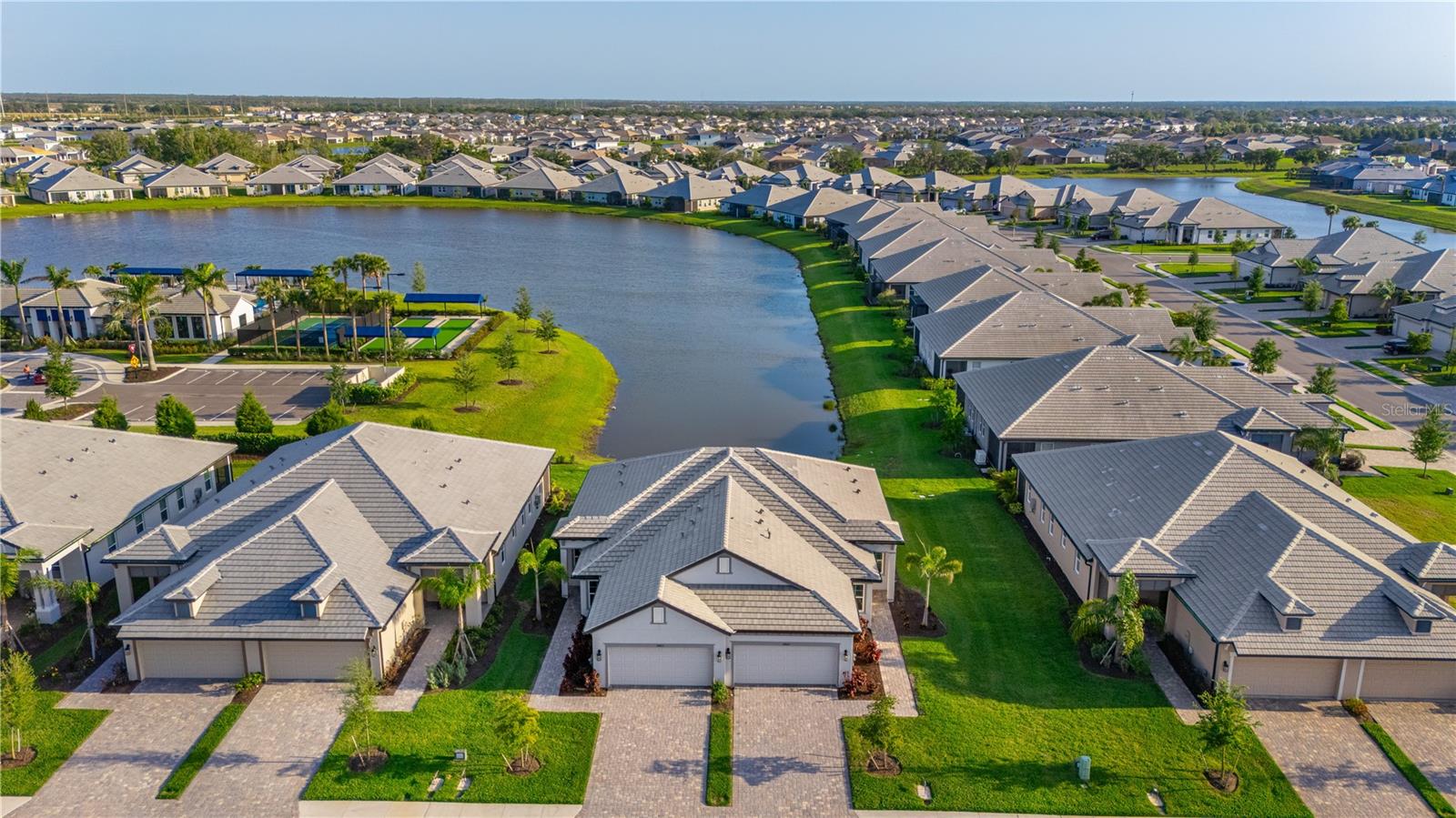 Experience upscale living in this beautifully upgraded 2-bedroom, 2-bathroom home with a dedicated office and tranquil water views. Luxury vinyl plank flooring flows throughout the open-concept layout, accented by elegant tray ceilings and enhanced can lighting. The extended lanai offers the perfect space to unwind while taking in the serene view. The gourmet kitchen features new GE Profile appliances, soft-close cabinetry with pull-outs, and a built-in trash system—combining style and function. The spacious primary suite is a peaceful retreat, complete with dual sinks, a walk-in closet, and a beautifully designed bathroom. Additional highlights include an epoxy-coated garage floor and a premium LG washer and dryer. Located just a short walk from resort-style amenities including a clubhouse, fitness center, pool, and a recreation complex with tennis and pickleball courts—this home offers a luxurious lifestyle in one of the community’s most desirable settings.
Furniture is optional!