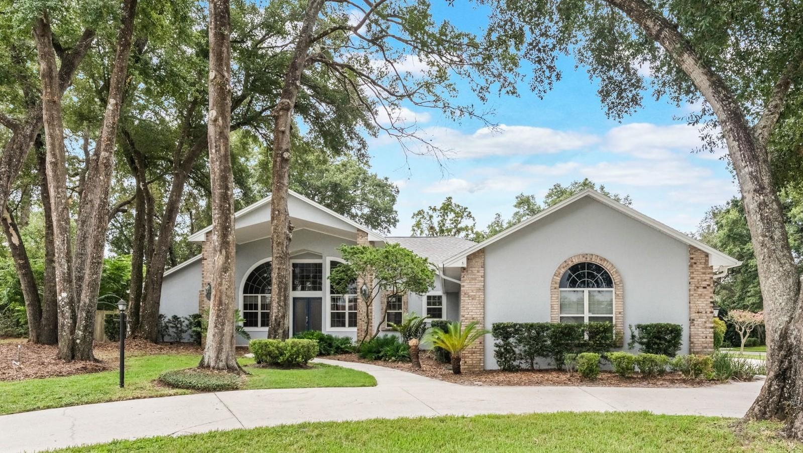 Spacious 5-Bedroom Pool Home on Over ½ Acre in Lake Mary’s Hidden Gem – Cardinal Oaks Cove. Welcome to your dream home in the heart of Lake Mary! Nestled on a private, oversized corner lot in the sought-after, oak-lined neighborhood of Cardinal Oaks Cove, this well maintained 5-Bedroom, 4-Bath Home offers approximately 3,100 sq. ft. of thoughtfully designed living space, including a Screened Pool, 3-car Side-Entry Garage, and Circular Driveway. Step inside to find a bright, open floor plan with vaulted ceilings, a floor-to-ceiling brick Fireplace, and French doors that invite natural light and lead to your private backyard oasis. The 3-way split Bedroom layout is ideal for multi-generational living or guest privacy, with a spacious mother-in-law or guest Suite tucked away on its own wing. At the heart of the home is a freshly updated Kitchen, featuring newly painted cabinetry, granite countertops, a breakfast bar, desk/coffee nook, and brand-new stainless steel appliances. Adjacent is a cozy dinette and an expansive Great Room (23x16) w/ Dining Area, perfect for entertaining. The large Office/Den/Living Room has French doors for privacy and perfect for many options. The oversized Primary Suite offers a peaceful retreat with a Sitting Area, pool views, French doors, and a spa-style Bathroom—complete with new dual vanities, a garden tub, walk-in shower, and new luxury vinyl plank (LVP) flooring. Outside, enjoy your own private paradise with a large covered Lanai, newly rescreened Pool enclosure, and a fully fenced backyard—ideal for pets, play, or entertaining a crowd. Recent Updates Include: Exterior painted (2025), Pool cage rescreened (2025), 2 new water heaters (2025), Stainless steel kitchen appliances (2025), New LVP flooring & vanities in Master Suite (2025), Interior painted (2024), Roof replaced (2022), Updated landscaping, fans, and more Located on a peaceful dead-end street between Lake Mary and Little Lake Mary, Cardinal Oaks Cove is known as “The Land Between the Lakes.” Enjoy the tranquility of a secluded neighborhood with easy access to boutique shopping, dining, Lake Mary’s Farmer’s Market, and top-rated schools—plus quick connections to I-4, 417, beaches, and Orlando’s top destinations. This is a rare opportunity to own a spacious, move-in-ready home in one of Lake Mary’s most exclusive communities—with no HOA. Schedule your private tour today!