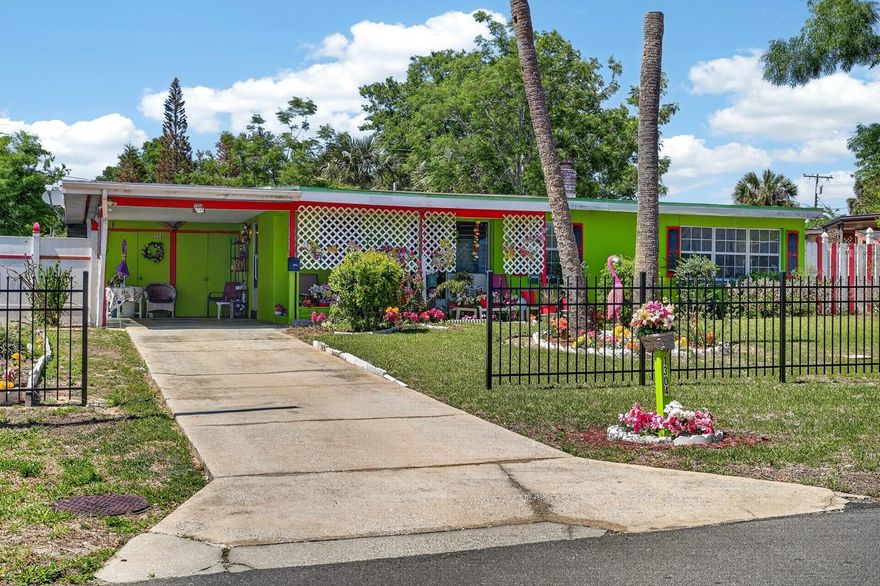 Charming and full of personality, this well-maintained Florida home stands out with its vibrant curb appeal and inviting atmosphere! Featuring a newer water heater (2023), this property offers peace of mind along with plenty of character inside and out.

Step inside to find a cozy layout with multiple living spaces, including a bright living room and a spacious bonus/sunroom, perfect for relaxing or entertaining. The home showcases unique touches throughout, from warm wood-paneled ceilings to large windows that bring in natural light.

Enjoy outdoor living with a fully fenced front yard, mature landscaping, and a generous backyard offering plenty of room to expand, garden, or create your own private retreat. A covered carport and extended driveway provide ample parking.

Conveniently located near shopping, dining, and major roadways, this home is ideal for buyers looking for affordability, charm, and potential all in one.