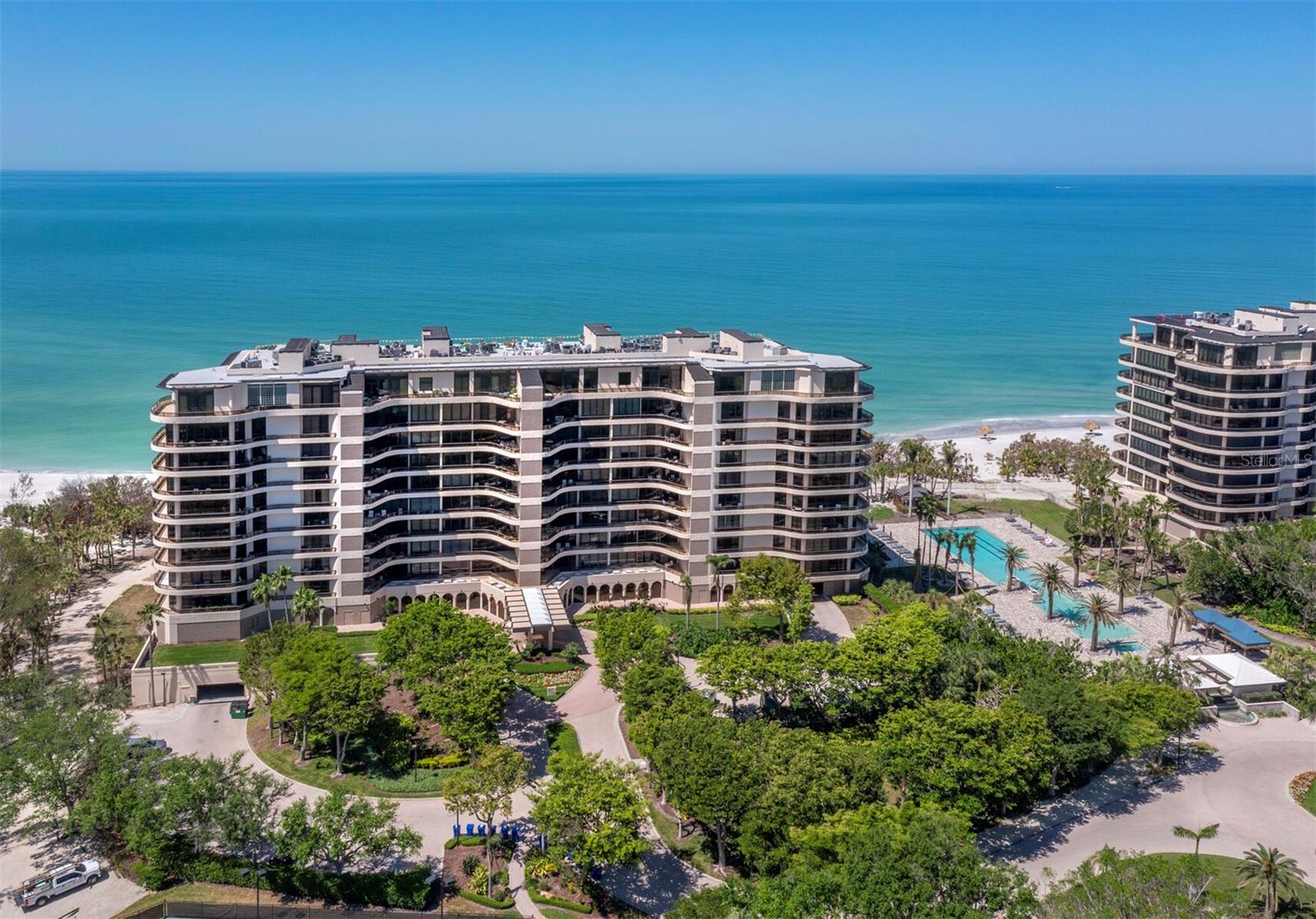 Exquisite Gulf-Front Residence at L’Ambiance. Presenting a truly rare opportunity—this direct Gulf-front 2-bedroom plus den residence offers the pinnacle of beachfront living at the prestigious L’Ambiance on Longboat Key. Featuring the coveted Sabal floor plan, this thoughtfully designed home boasts both sunrise and sunset terraces. Start your mornings with serene eastern light and end your day with sweeping, unobstructed views of the Gulf from your expansive western terrace. Effortlessly blending refined coastal style with luxurious finishes, the residence offers a spacious layout with two bedrooms and a versatile third space—ideal for a home office or guest room—paired with a nearby full bath. The Gulf-front primary suite is a peaceful retreat with panoramic water views, direct terrace access, abundant closet space, and dual bathrooms designed for privacy and comfort. L’Ambiance is Longboat Key’s premier beachfront community, offering an exceptional lifestyle with a 24-hour staffed gatehouse and full-time concierge, a resort-style beachfront pool surrounded by lush tropical landscaping, and two Har-Tru tennis courts. The state-of-the-art fitness center includes his and her locker rooms, and residents enjoy access to game and billiard rooms, a wine room, and a private library. Three elegantly appointed guest suites are available for visiting friends and family.
Additional highlights include secured underground parking, a private storage locker, and an unbeatable location just moments from the shops and dining of St. Armands Circle. The residence is also within walking distance to the Longboat Key Club’s acclaimed restaurants and resort amenities. This is beachfront living at its most luxurious—an extraordinary coastal retreat that rarely becomes available.