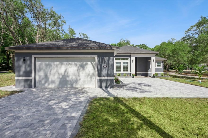 Welcome to this beautifully crafted new construction home, perfectly situated on an oversized  corner lot with an extended paver driveway and lush, eye-catching landscaping that creates incredible curb appeal.

Step inside to discover soaring vaulted ceilings and an open, airy layout filled with natural light. The chef’s kitchen is the heart of the home, featuring abundant cabinetry for storage, sleek quartz countertops, and stainless steel appliances—perfect for both everyday living and entertaining.

The primary suite is a true retreat, showcasing custom woodwork, elegant tray ceilings, and generous natural light. The spa-inspired primary bathroom offers a dual-sink vanity, a large walk-in shower with a rainfall showerhead, an oversized soaking tub, and beautiful tilework throughout.

Designed with convenience in mind, the laundry room includes a utility sink and ample storage space. Step out back to the spacious lanai, complete with a wet bar and plenty of room for seating and outdoor living—ideal for relaxing or hosting guests year-round.

This home combines modern luxury, thoughtful design, and exceptional indoor-outdoor living—don’t miss your opportunity to make it yours.