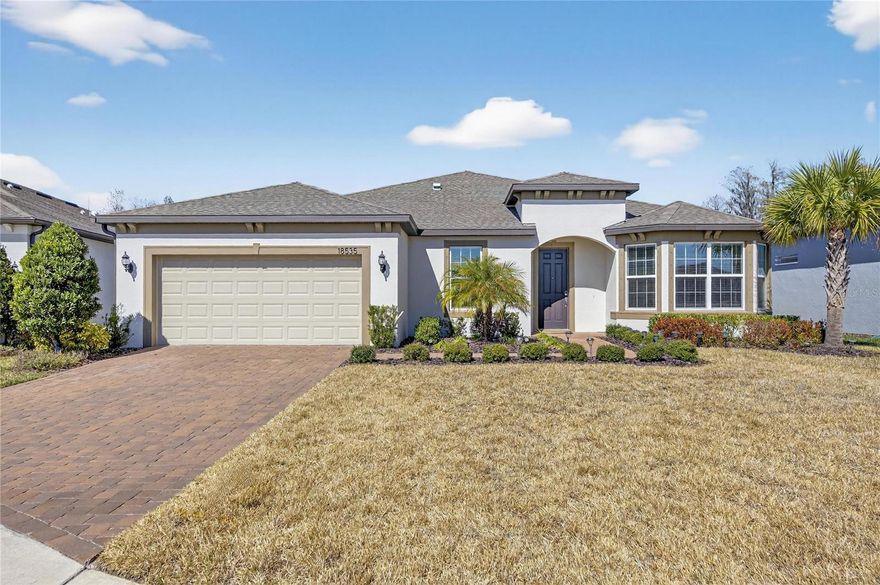 Ready for Resort Style Living? Enjoy the best of 55+ active adult living in this stunning Stardom home that features 2 Primary Bedroom/ Bathroom Suites + Den + 1/2 Guest Bath and a 2 Car garage with extra storage space.  This oversized lot feature remarkable POND VIEWS and located in the newest phase of the Gated, Golf cart friendly community of Del Webb Bexley. The 19,000 SF clubhouse offers homeowners a fitness center, ball room, multi-purpose rooms, clubs, planned activities, bistro and more! Outdoors you will enjoy bocce ball, pickle ball, tennis, a resort style zero entry heated pool with lap lanes and an additional walking resistance pool, spa, community garden and even a dog park. Only a short stroll to the amenities, this move-in ready home blends luxury upgrades with unmatched convenience and looks like new. Inside, you’ll find nearly every available upgrade: luxury vinyl plank flooring throughout, custom cabinets and sleek countertops, 8 foot interior doors and crown molding. The open-concept gourmet kitchen boasts a large island with seating for four, walk-in pantry, stainless steel appliances and includes the entertainment pkg. that consists of a separate dry bar area with space for wine refrigerator.  The kitchen flows seamlessly into the dining and living areas, all with tranquil water views and sliding doors to the spacious screened lanai—perfect for entertaining or enjoying peaceful outdoor time. A standout feature of this floor plan are the two oversized owner's suites. The primary suite is a true retreat, featuring a pond view with luxurious en-suite bath that has dual sinks, a spacious custom-tiled walk-in shower, linen closet and large walk-in closet. The second bedroom suite also includes the same water view on the opposite corner of the home, a full private bath and walk-in closet, providing comfort for your guests, rather they are living with you indefinitely or only visiting for a short time.  Additional highlights include a spacious flex room with french doors and a thoughtfully designed garage entryway with a large wooden coat/shoe rack that has been gifted to you —the perfect drop zone for everyday convenience. Adjacent to the two car epoxy finished garage is a massive storage area (11 ft x 15 ft), an ideal space for a shop or just to hold all your valuable keep sakes / storage items in.  Laundry won't be a burden, as you'll enjoy this abundant laundry room with overhead storage and utility tub.  Move-in ready and looking like new, this Stardom home at 18535 Coastal Shore Terrace in Land O Lakes, FL offers a private pond view delivering the best of comfort, luxury, and active living. The HOA monthly fee includes internet and cable, use and maintenance of state of the art amenities, landscaping within the common areas inside of the gates and maintenance of the landscape within your home site.  A full time activities director and her staff will keep you as busy as you want to be! Del Webb Bexley is conveniently located near shopping, restaurants, the Tampa Premium Outlet Mall, medical facilities, Florida’s west coast beaches and Tampa’s International airport.