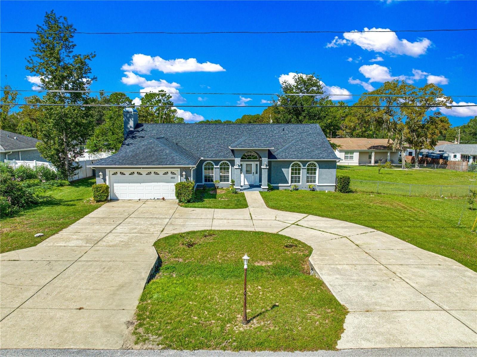 Plenty of room for everyone! This spacious home with cathedral ceilings offers over 2600 sq ft of living space including a spacious master bedroom with large ensuite, 3 additional bedrooms with built in closets, large bathroom with double sinks, a cozy living room with propane fireplace, updated chef style kitchen, breakfast nook, storage pantry, formal dining room, additional living/family room, inside laundry room with sink and storage, oversized 2 car garage, a full size inground pool with screened enclosure and a covered patio. While the entire home has central heating and air, EACH bedroom also has their own mini split for personalized climate control AND the oversized garage has its own mini split for personalized climate control. Updates include exterior and interior paint, LED lights throughout the home, luxury vinyl throughout, kitchen remodel with stone countertops new cabinets and updated appliances, new pool filtration system and epoxy floor in garage. No HOA. Located close to shopping, medical facilities, schools, hospitals, dining and more. This home sits on a .26-acre lot, and there is an additional .26-acre lot that is also available to purchase for a large yard OR to build a garage, workshop or another home. Don't miss out on this spacious home in a great location!