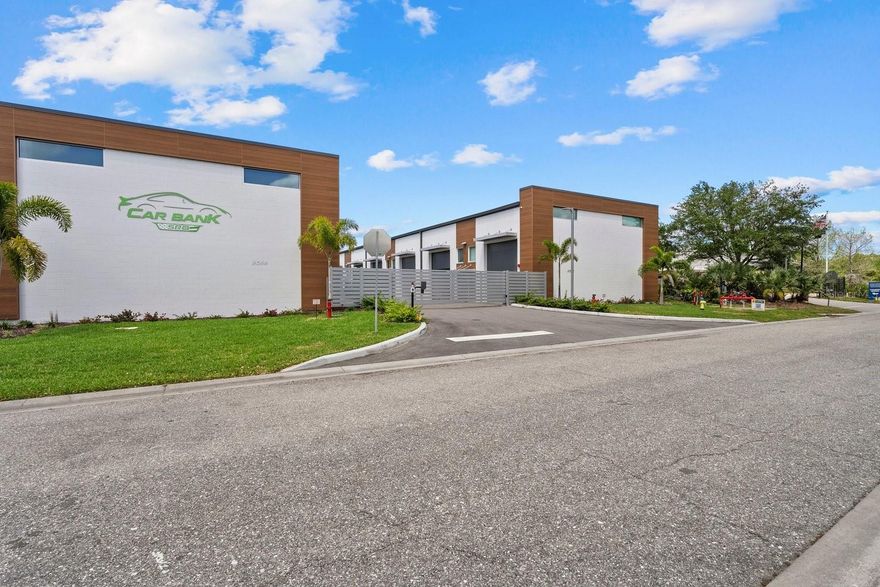 Price Reduced! An exceptional opportunity to own a garage condominium at Car Bank SRQ in Palmer Ranch, created for discerning car collectors, boating enthusiasts, RV owners, and those seeking a private, highly versatile space in a premier Sarasota location. Just moments from Legacy Trail, this unit offers the convenience of keeping bikes stored and ready for an effortless ride whenever the mood strikes. Inside, approximately 1,300 sq ft unfolds beneath soaring 20-foot ceilings, creating an impressive open space with endless potential—including the ability to easily accommodate a car lift. An impressive wide staircase leads to the mezzanine level, currently an open area ready to be transformed into a refined lounge, office, or additional storage. A half bath is positioned beneath the stairs and can easily be converted to a full bath with the existing shower rough-in, and a utility sink adds everyday convenience. The oversized 14'H x 12'W garage door allows for easy access. Owners also enjoy access to an on-site detail bay, a valuable private amenity for keeping vehicles clean and showroom-ready. Climate-controlled and located within an exclusive gated community of just 18 units, this is a rare chance to create a customized retreat designed to showcase your lifestyle, your passions, and your collection.  
Garage floor dimensions: 23.5 ft wide x 40 ft deep | Mezzanine dimensions: 23.5 ft wide x 12 ft deep x 10 ft high