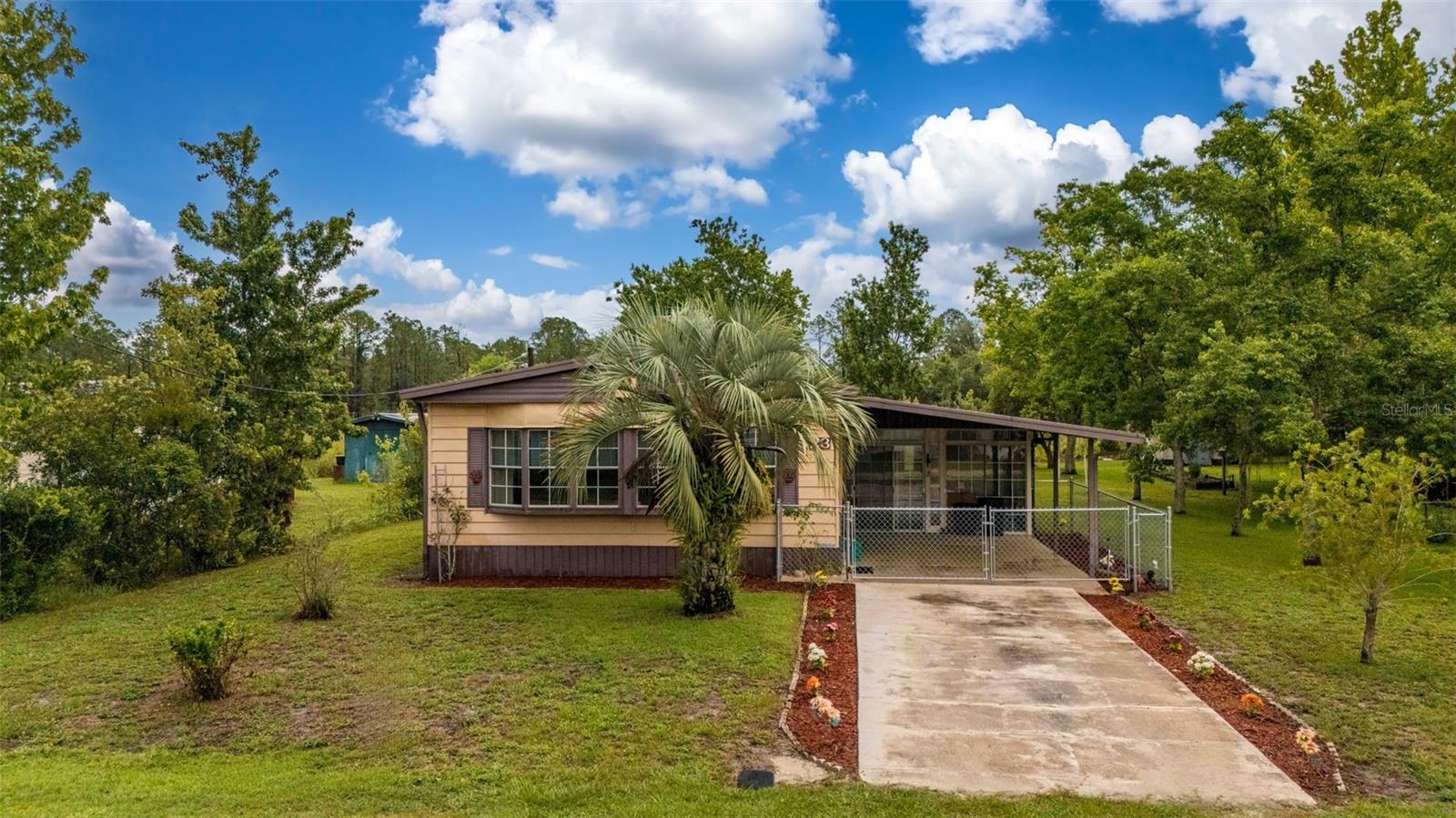 Lakefront 2BR/2BA Home on Lake Laverne - Crescent City, FL Charming 2 bedrooms, 2 baths situated on a large lot. Recent upgrades include new carpeting, blinds throughout, and fresh interior paint. Enjoy the bright sun porch, covered carport, and a peaceful setting just minutes from a boat ramp and marina on the St. Johns River. Close to local favorite Renegades on the River for dining and entertainment. Perfect for a weekend retreat or full-time living—don't miss this Crescent City gem!