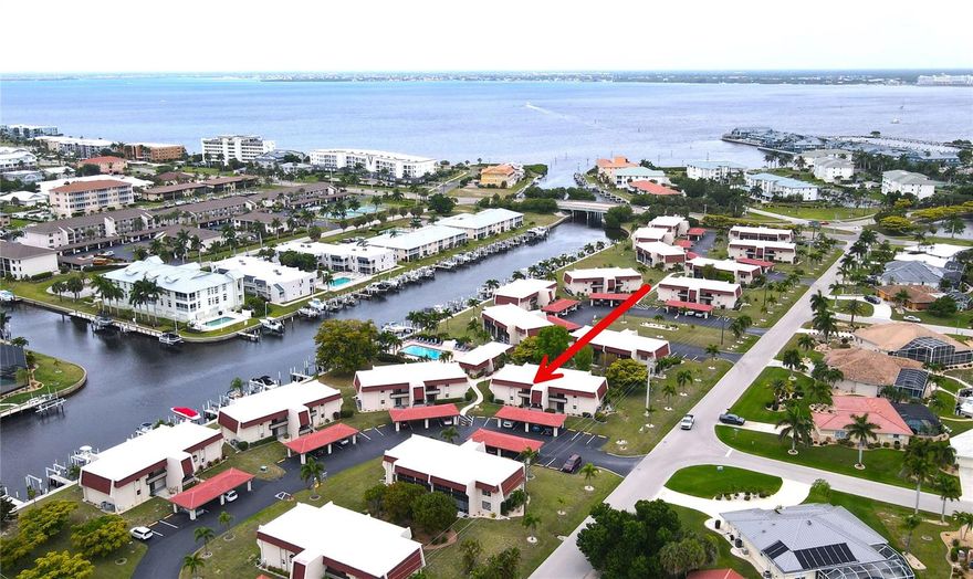 **PLEASE ENJOY THE 3D INTERACTIVE VIRTUAL TOUR ASSOCIATED WITH THIS LISTING – Are you looking for the perfect Condo? Then look no further than this fully furnished, TURN KEY!  Along with two bicycles! This second-floor, two-bedroom, two-bath home with two screened lanais and a carport is waiting just for you! Other extra features include brand new AC unit and flooring. Gateway Point is nestled in the center of the waterfront community of Punta Gorda Isles. It offers an open floor plan with living and dining rooms and a fully equipped kitchen with a breakfast bar that opens to the main living area for convenience and entertaining. The spacious primary en-suite bedroom has sliders onto its own screened lanai. The great room also has a screened lanai... and both overlook a community green space. Other key features include a dedicated utility room with a combined washer and dryer and water and sewer service are included in your condo fee! Gateway Point is a small waterfront community of just 68 units. The community amenities include a waterfront heated pool for year-round enjoyment with brand new pool furniture, a clubhouse and assigned covered parking with adjacent guest parking. In close proximity to local waterways and beaches, dining, shopping and golf courses make this property ideal for the Florida lifestyle. Easy access to public boat ramps provide access to many waterways, including beautiful Charlotte Harbor, the Peace and Myakka Rivers and the Gulf of Mexico. From this location, you are one mile from historic downtown Punta Gorda and the popular Fishermen’s Village complex with its quaint shops and cafes. So don’t wait to start enjoying your piece of Florida paradise! Click on the interactive 3D tour to view this property today!
